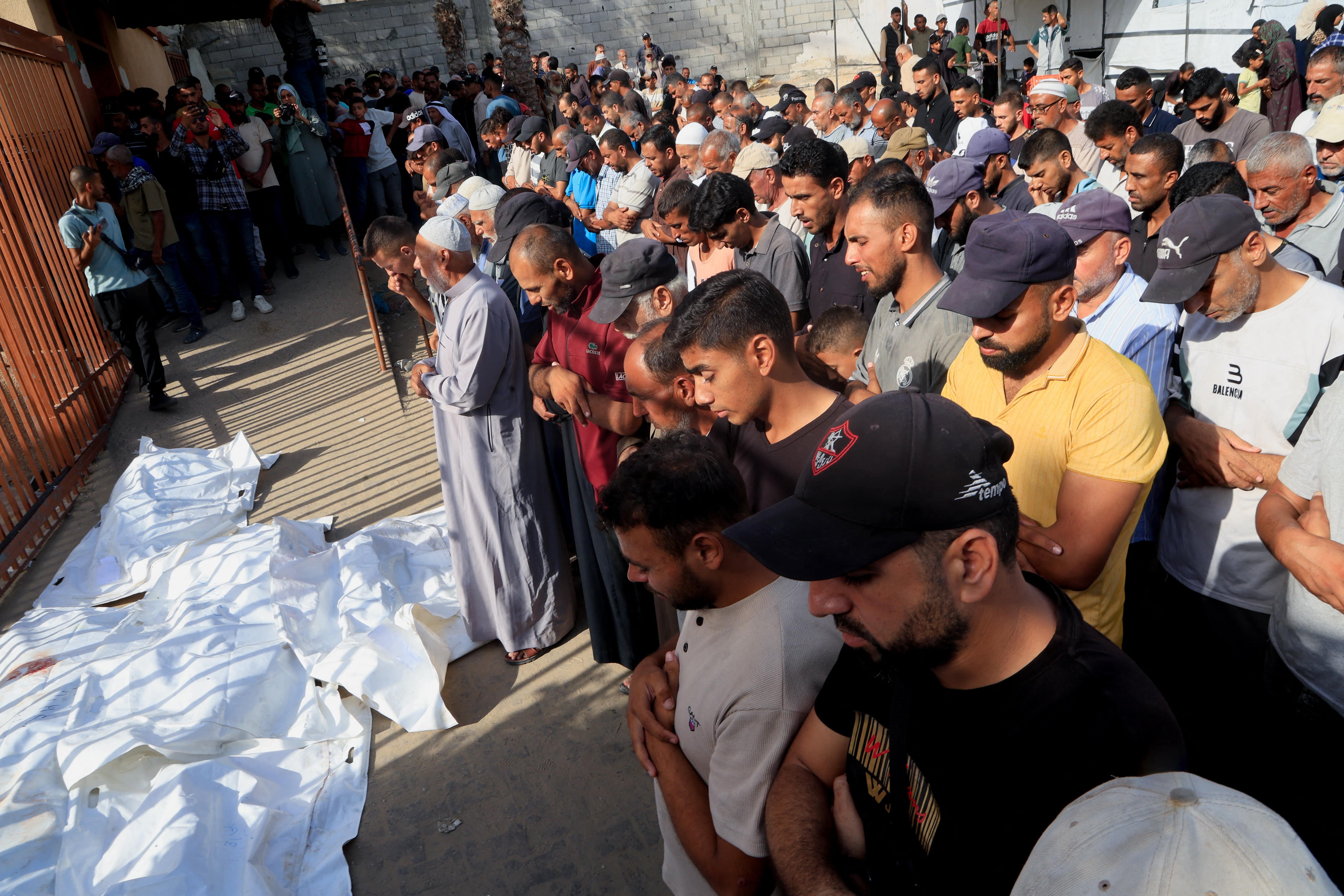 Mourners pray during the funeral of Palestinians killed in an overnight Israeli airstrike on their tent, according to medics, at Nasser Hospital in Khan Younis in the southern Gaza Strip, August 19, 2025. R