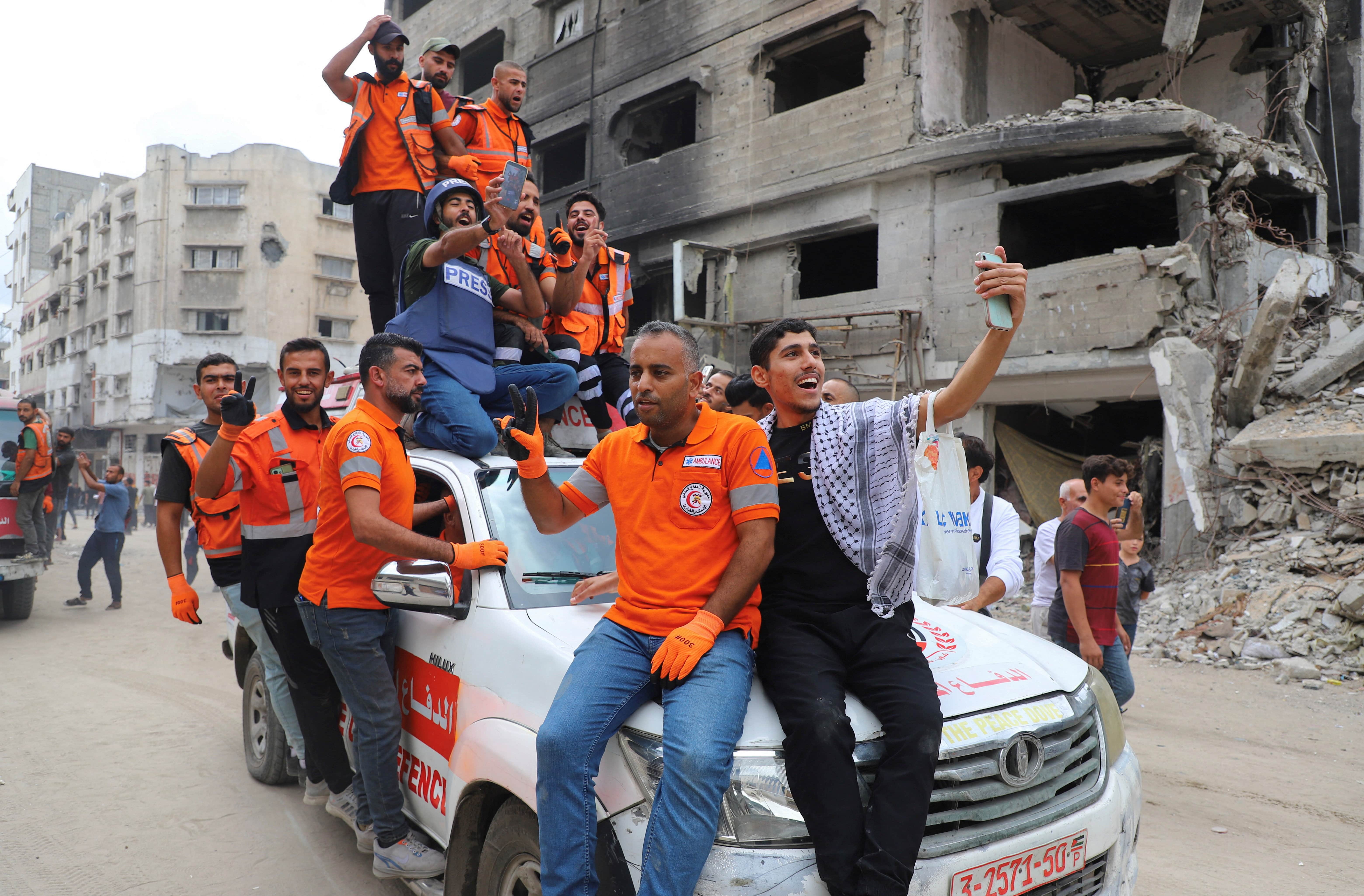 Palestinian emergency personnel celebrate, after U.S. President Donald Trump announced that Israel and Hamas agreed on the first phase of a Gaza ceasefire, in Gaza City, October 9, 2025. REUTERS