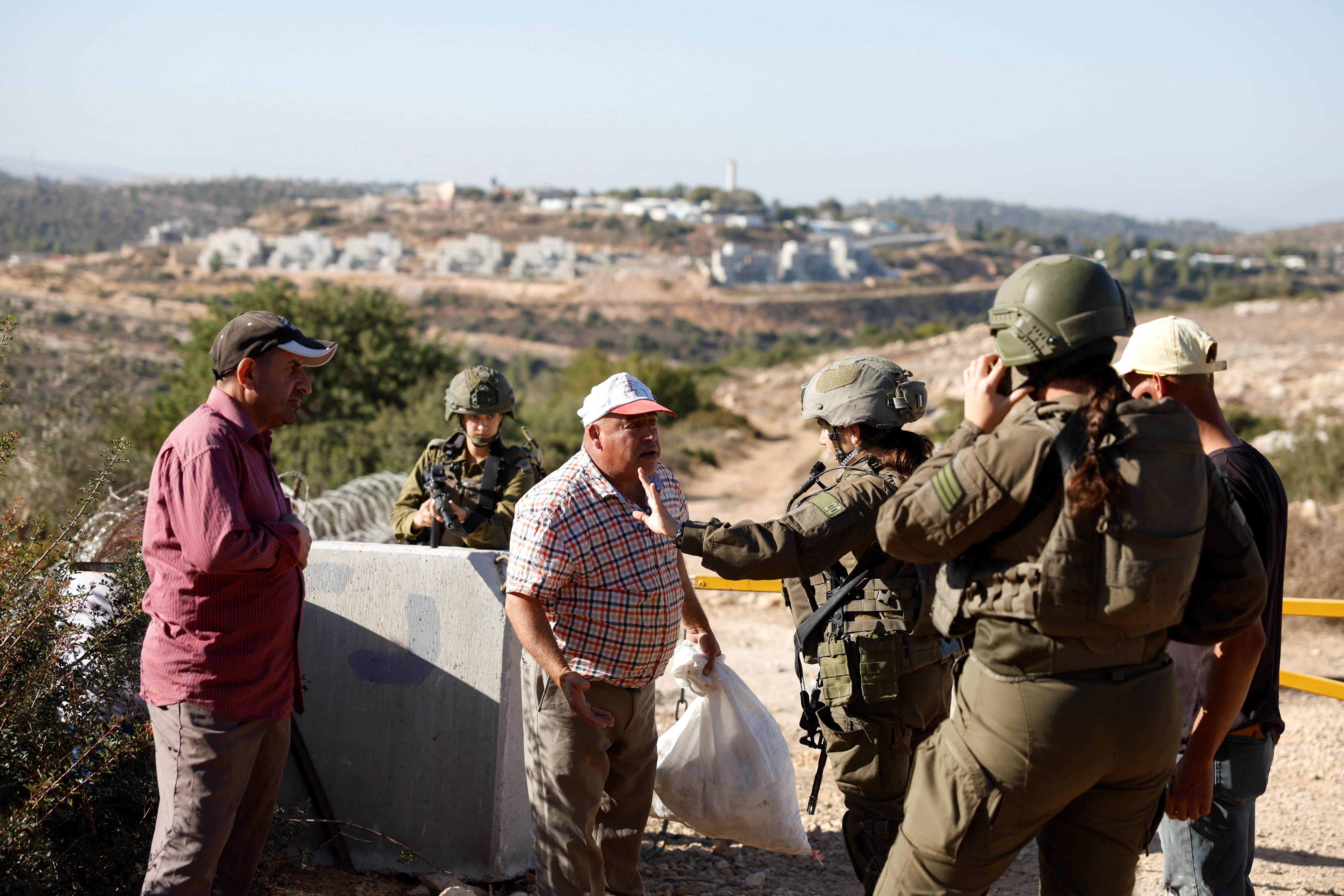 Israeli forces hinder access of Palestinians to olive trees during olive harvest, in the village of cooper, near Ramallah, in the Israeli-occupied West Bank, October 25, 2025. REUTERS