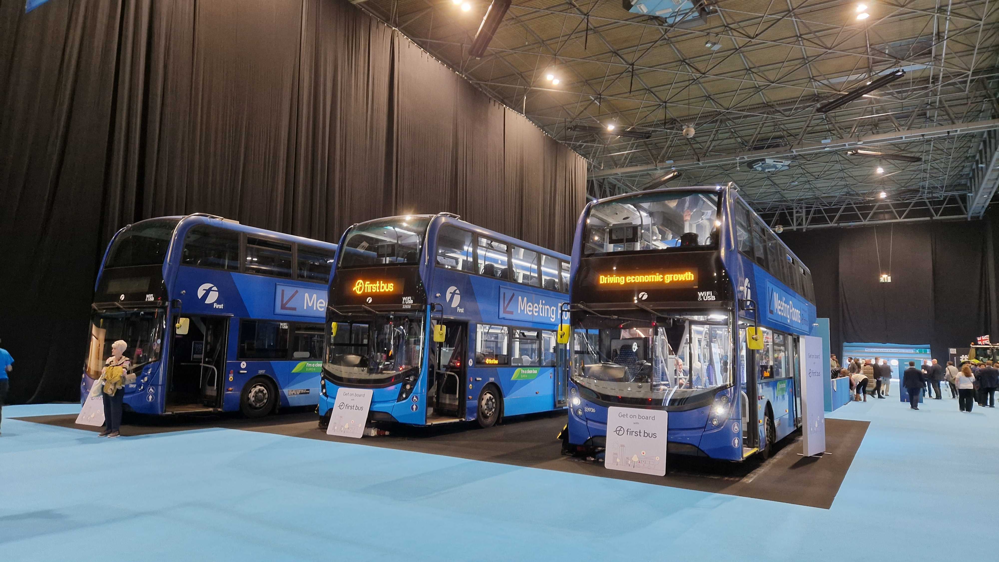 Three of the six buses in the Reform conference. (Imran Mulla/MEE)