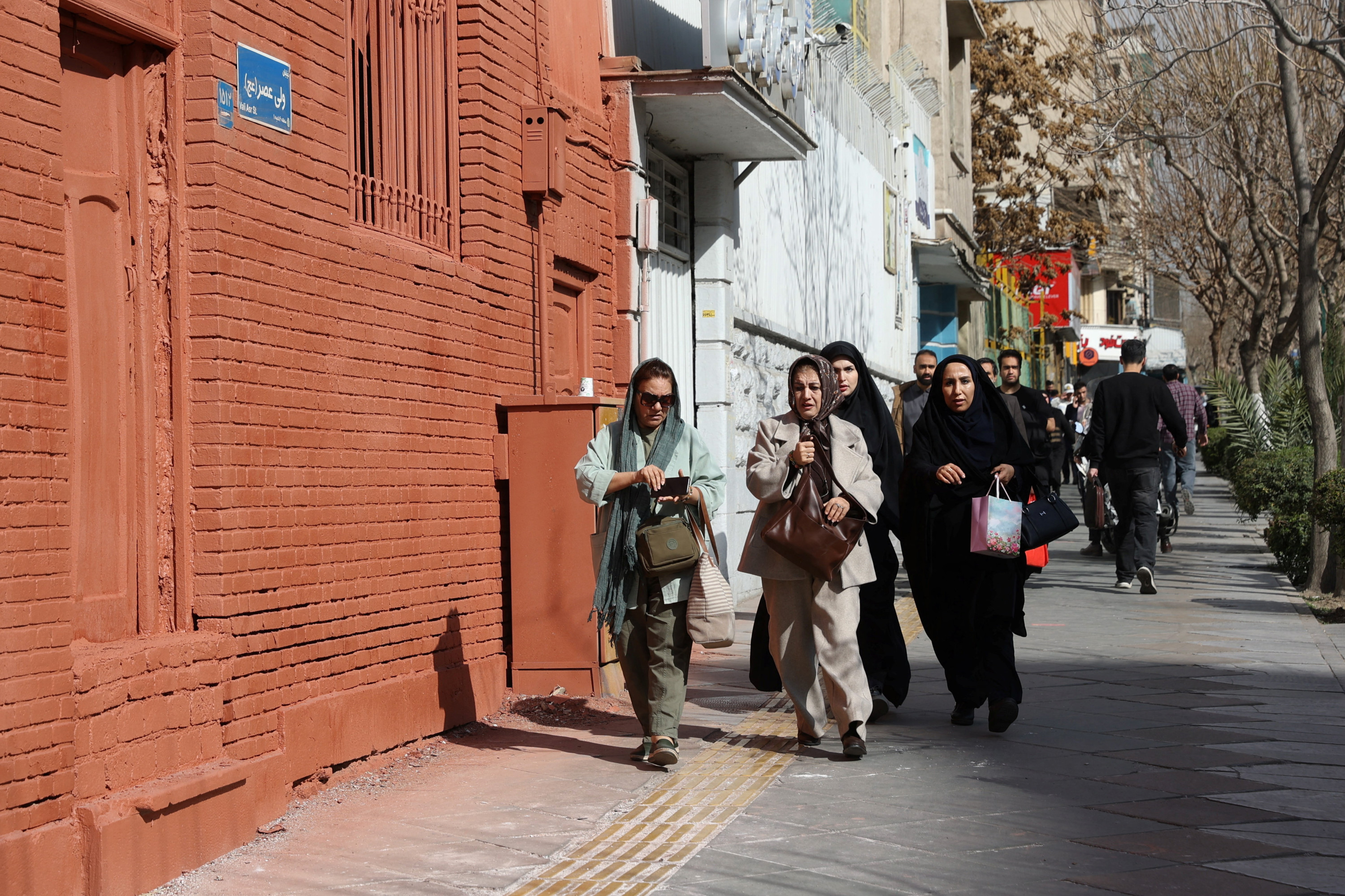 People run for cover following an explosion in Tehran, Iran 28 February 2026 (Majid Asgaripour/WANA via Reuters)