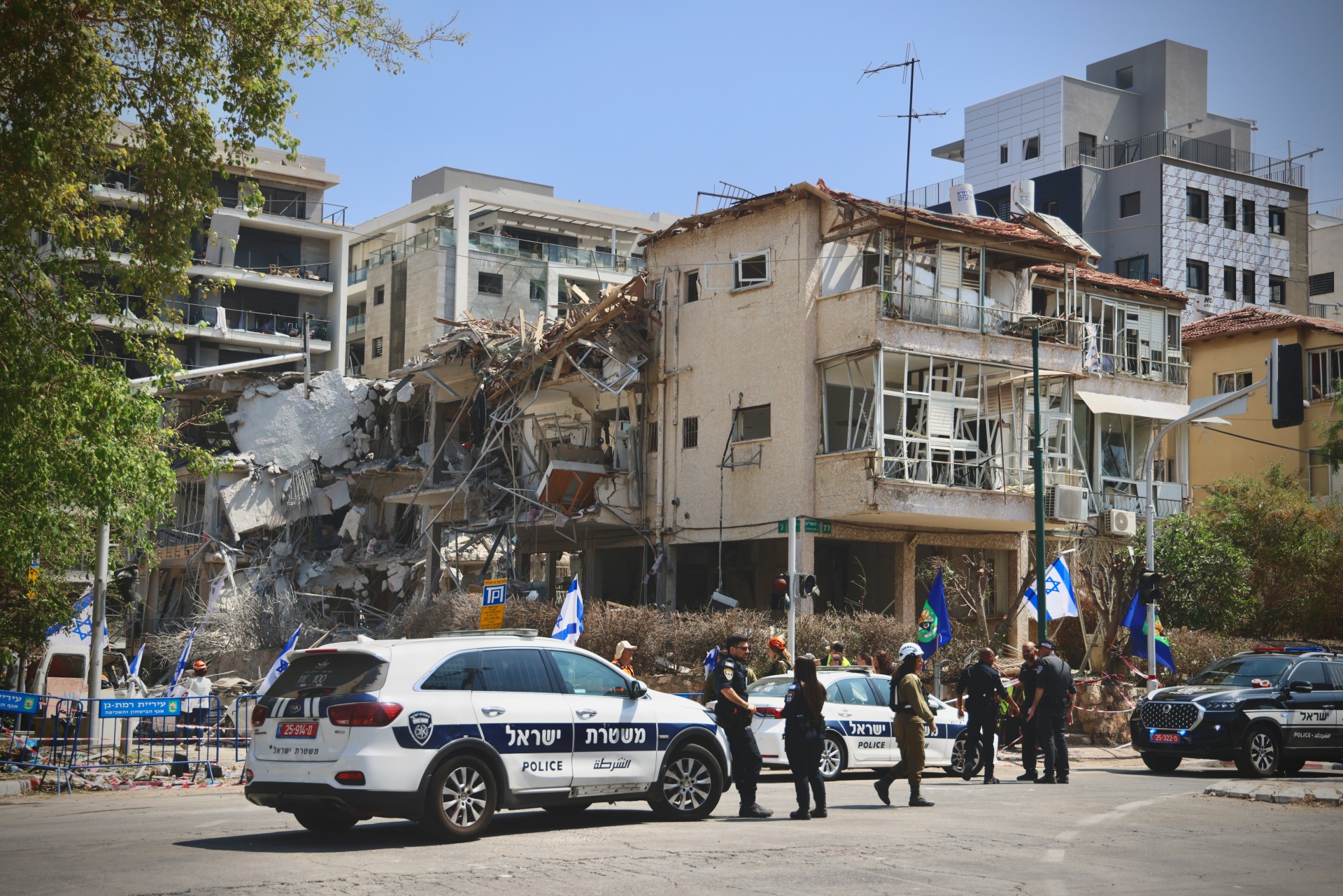 Israeli security forces set up a cordon near destroyed houses in Tel Aviv on 14 June 2025 (MEE/Faiz Abu Rmeleh)