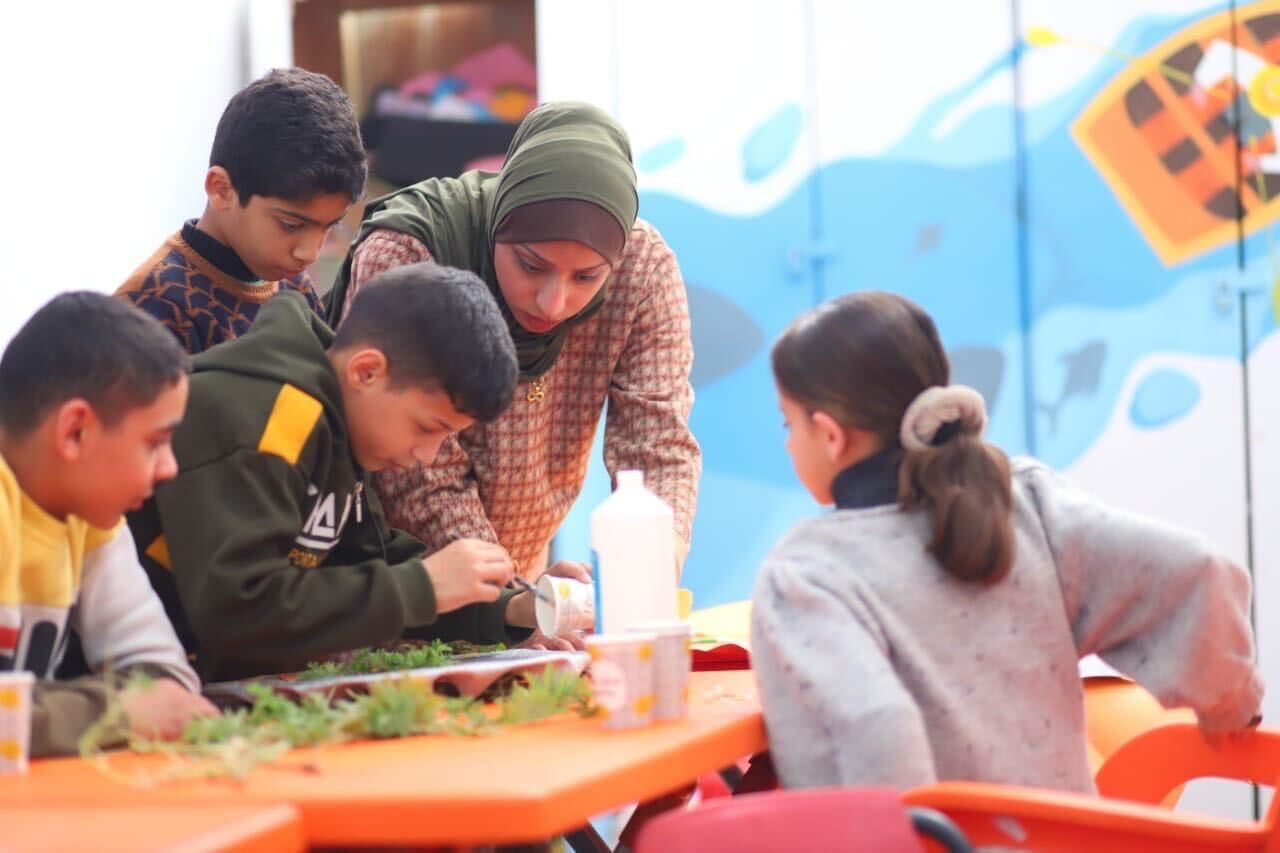 The author leads a science activity with students at a school in Rafah in an undated 2023 photo, taken before Israel’s war on Gaza (Ruwaida Amer/supplied)