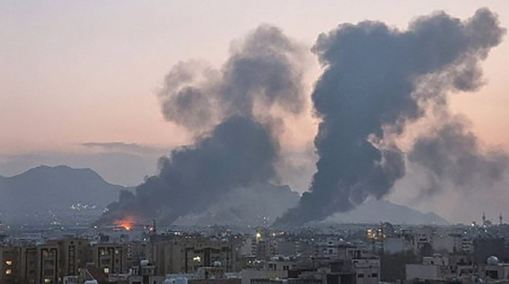 A UGC image posted and shared on social media on March 14, 2026, shows smoke plumes rising over the Iranian city of Isfahan after strikes. 