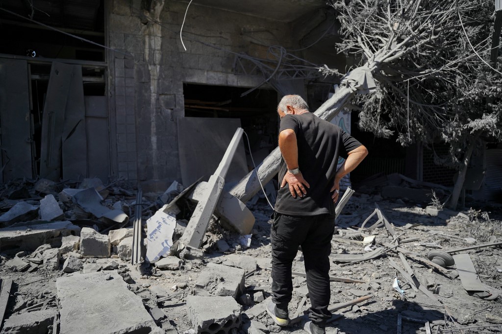 A man inspects the damage at the site of an Israeli strike that targeted an area in in the southern Lebanese city of Nabatieh on June 21, 2026.