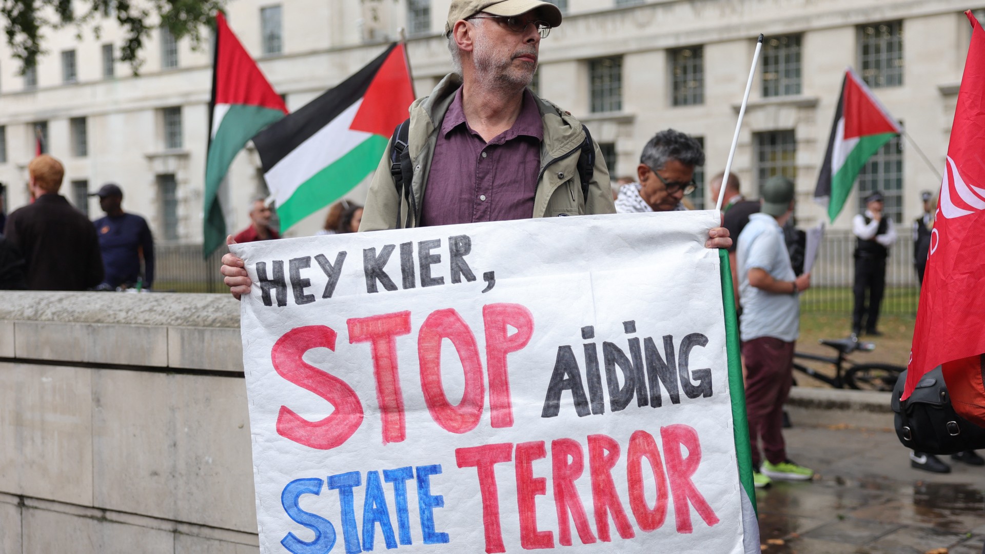 A protester holds a banner with a message to Britain's Prime Minister Kier Starmer during a vigil for journalists killed in Gaza outside Downing Street in central London on August 27, 2025-afp