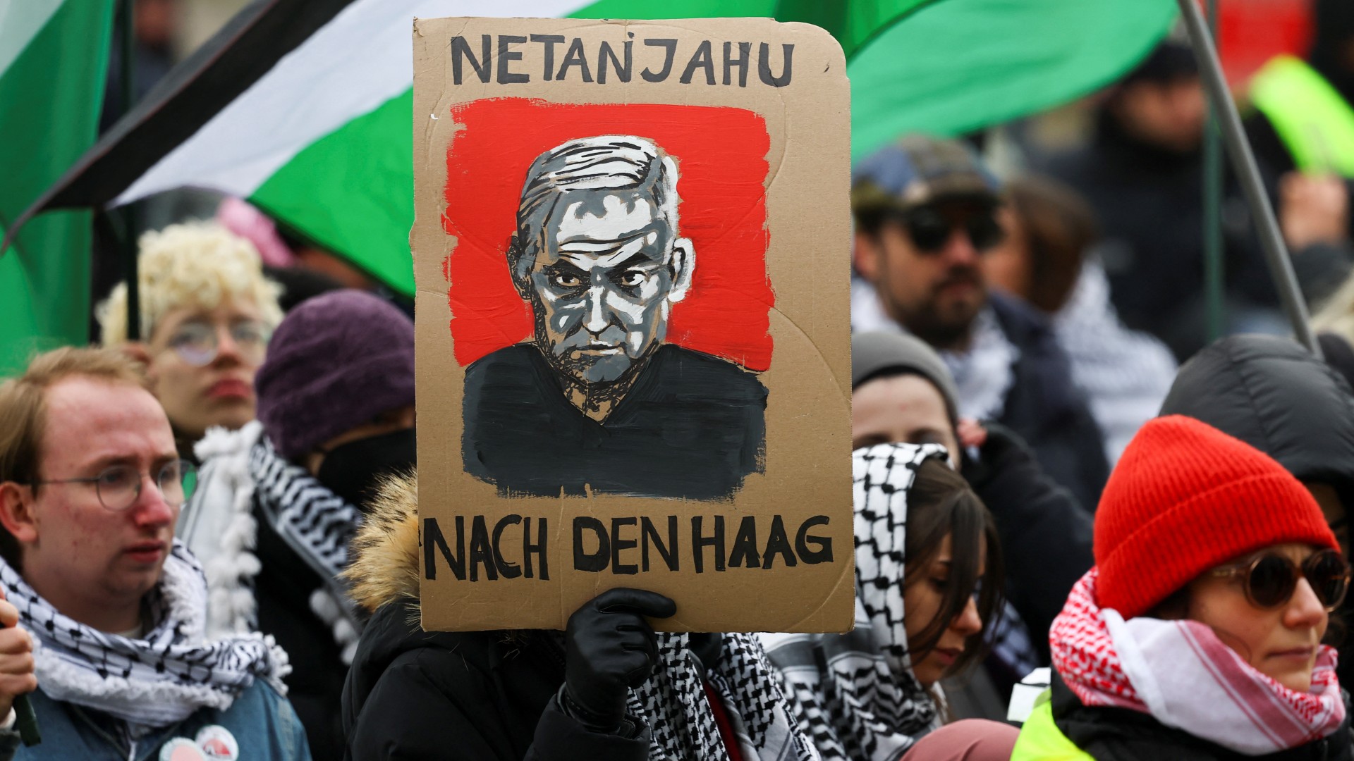 A protester holds a placard with an image depicting Israeli Prime Minister Benjamin Netanyahu during a demonstration in Munich, Germany on 15 February, 2025 (Reuters)
