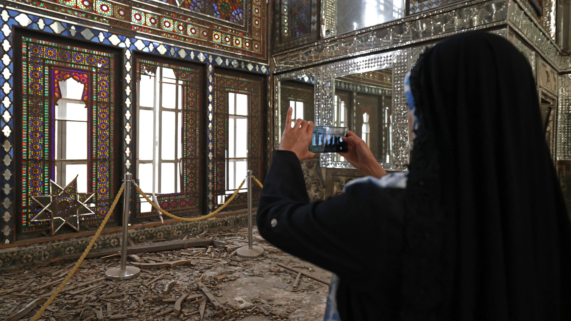 A visitor takes pictures of the damaged interiors of the historic Golestan Palace in Tehran on April 4, 2026 (AFP)