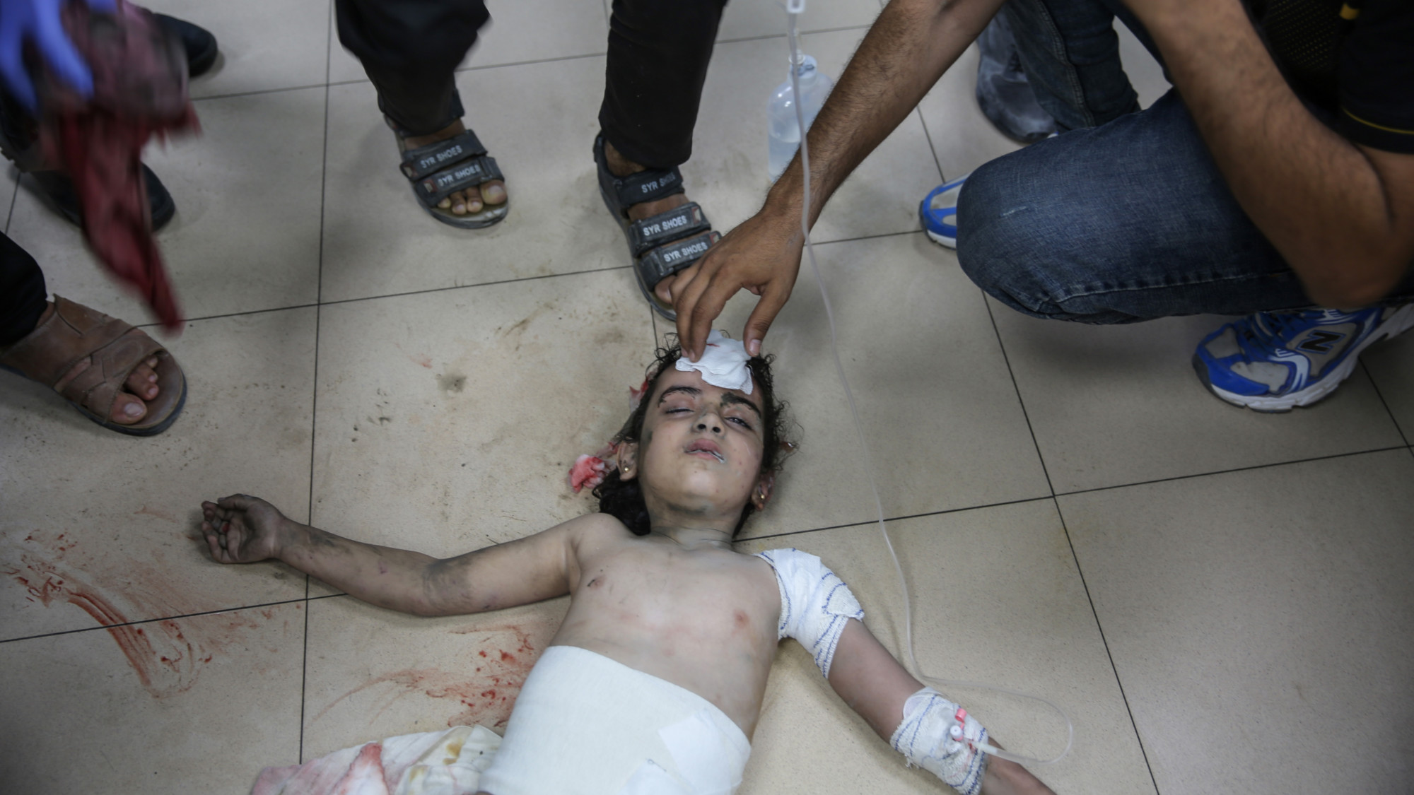 A child lies lifeless at al-Aqsa Some of those killed on Friday were fishermen shelled by Israeli warships on the beach of Deir al-Balah (MEE/Mohammed al-Hajjar)