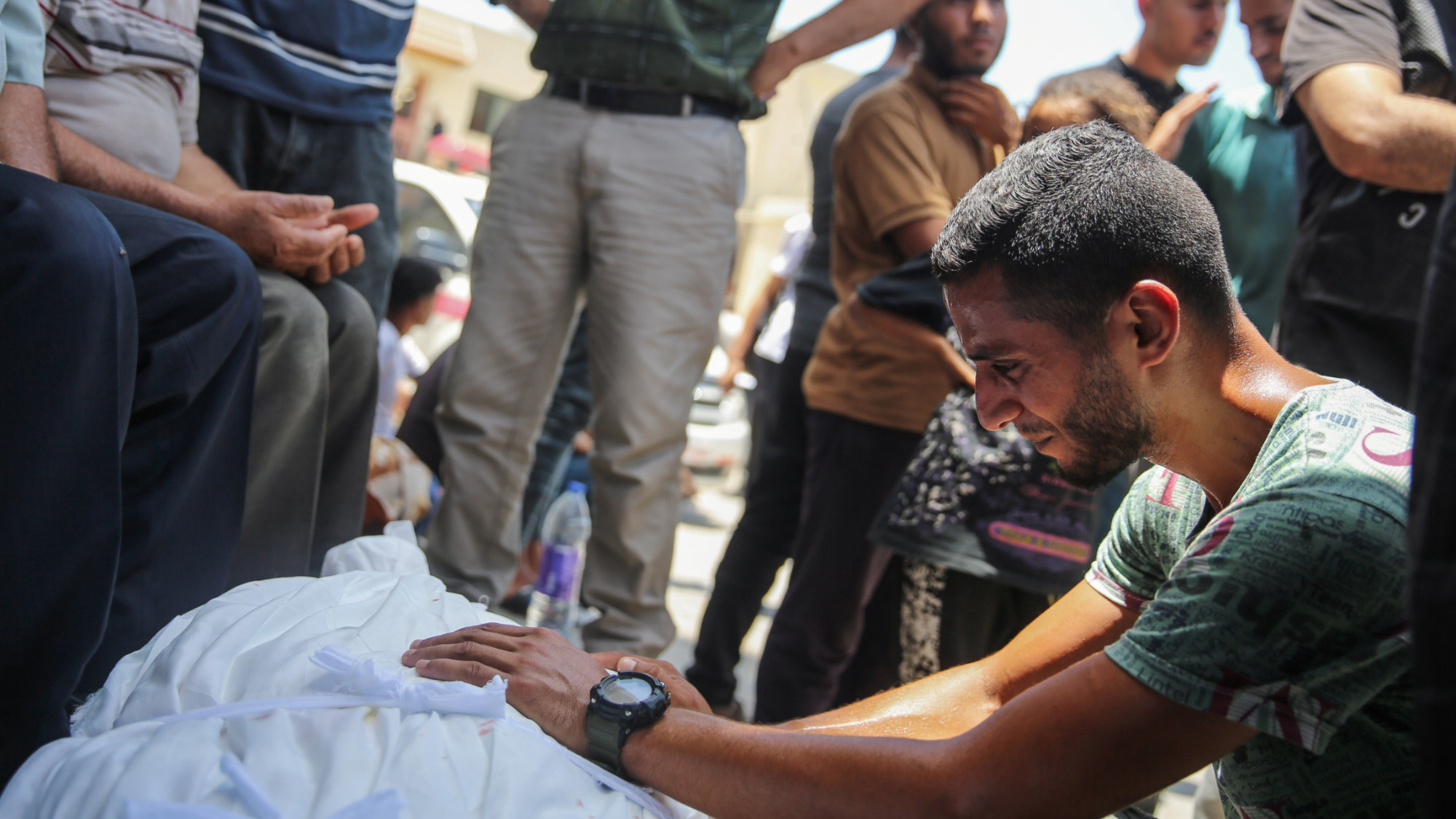A child lies lifeless at al-Aqsa Some of those killed on Friday were fishermen shelled by Israeli warships on the beach of Deir al-Balah (MEE/Mohammed al-Hajjar)
