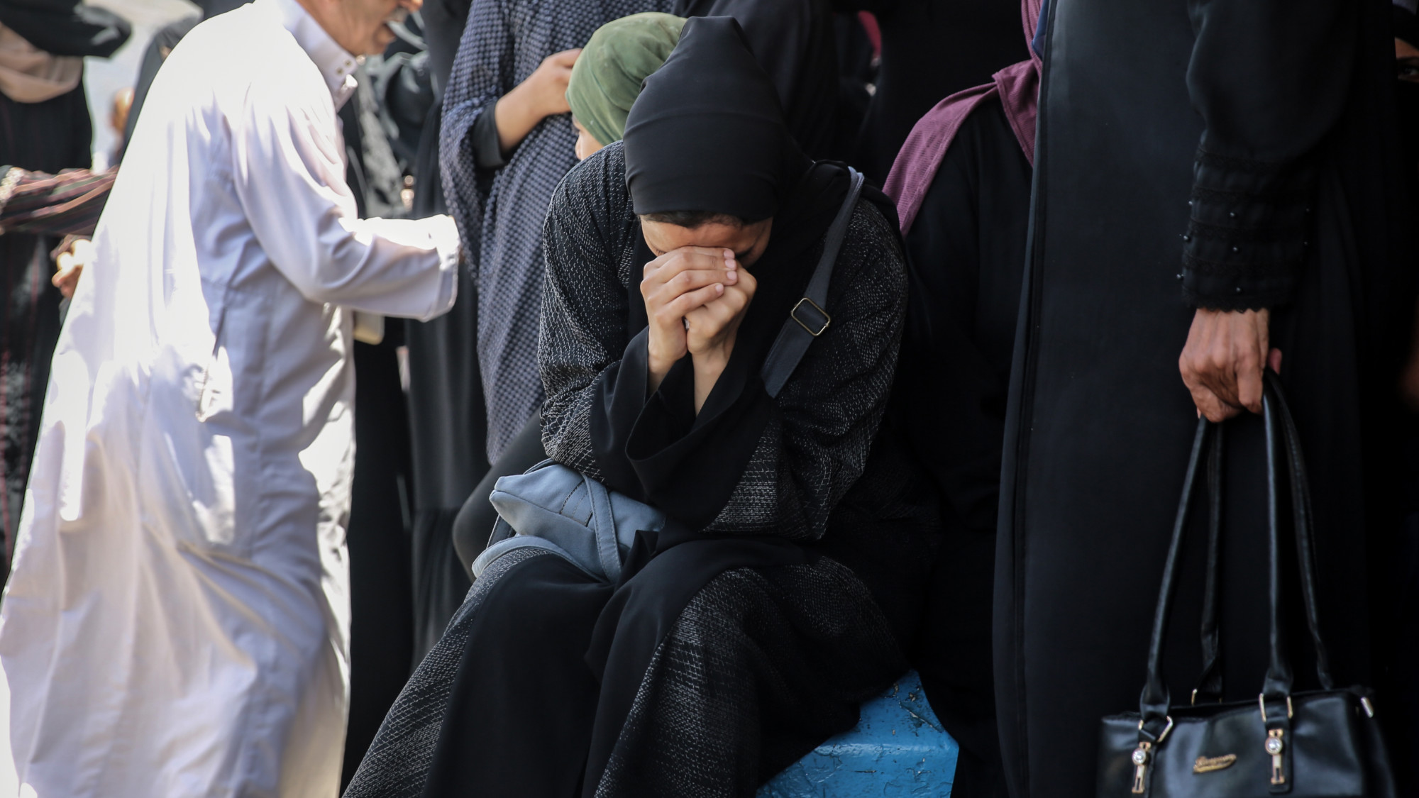 A women mourns the death of a relative outside the al-Aqsa Some of those killed on Friday were fishermen shelled by Israeli warships on the beach of Deir al-Balah (MEE/Mohammed al-Hajjar)