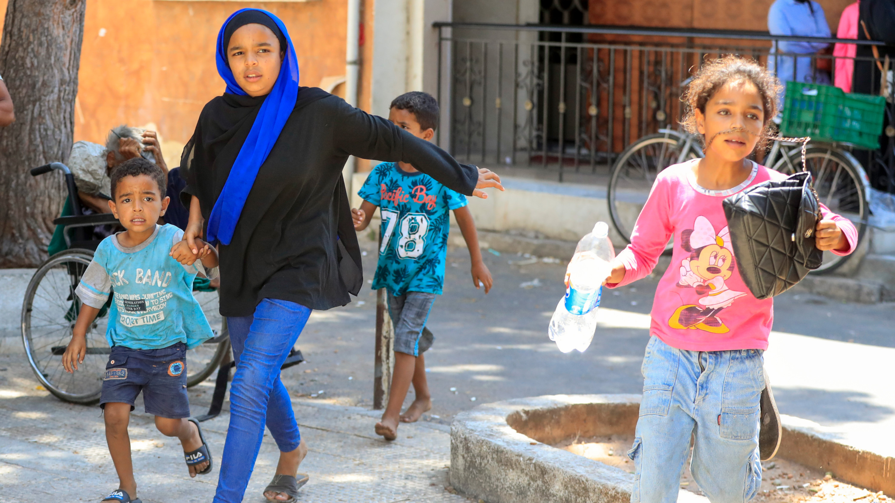 Palestinian residents flee their home after clashes inside the Ain al-Helweh refugee camp in the southern Lebanese city of Saida on 30 July 2023 (AP)