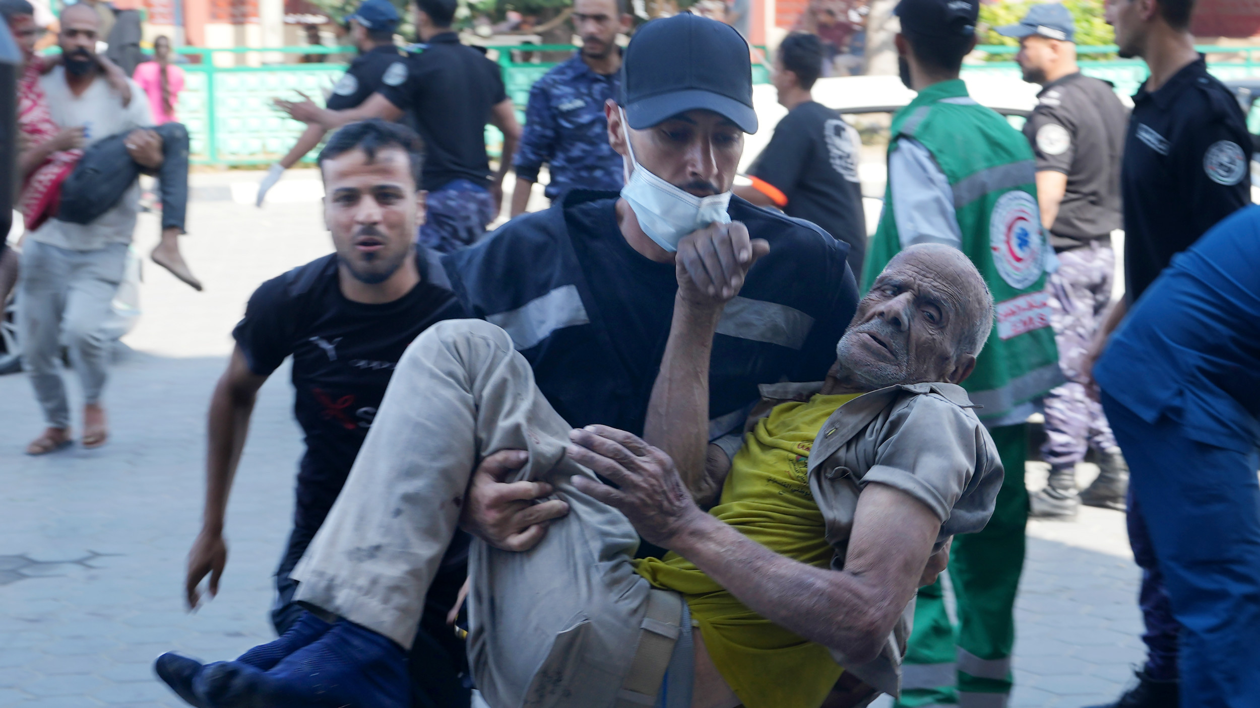 Elderly Palestinian wounded in Israeli air strikes are brought to al-Aqsa hospital in Deir el-Balah City, Gaza Strip, on 14 October 2023 (AP)