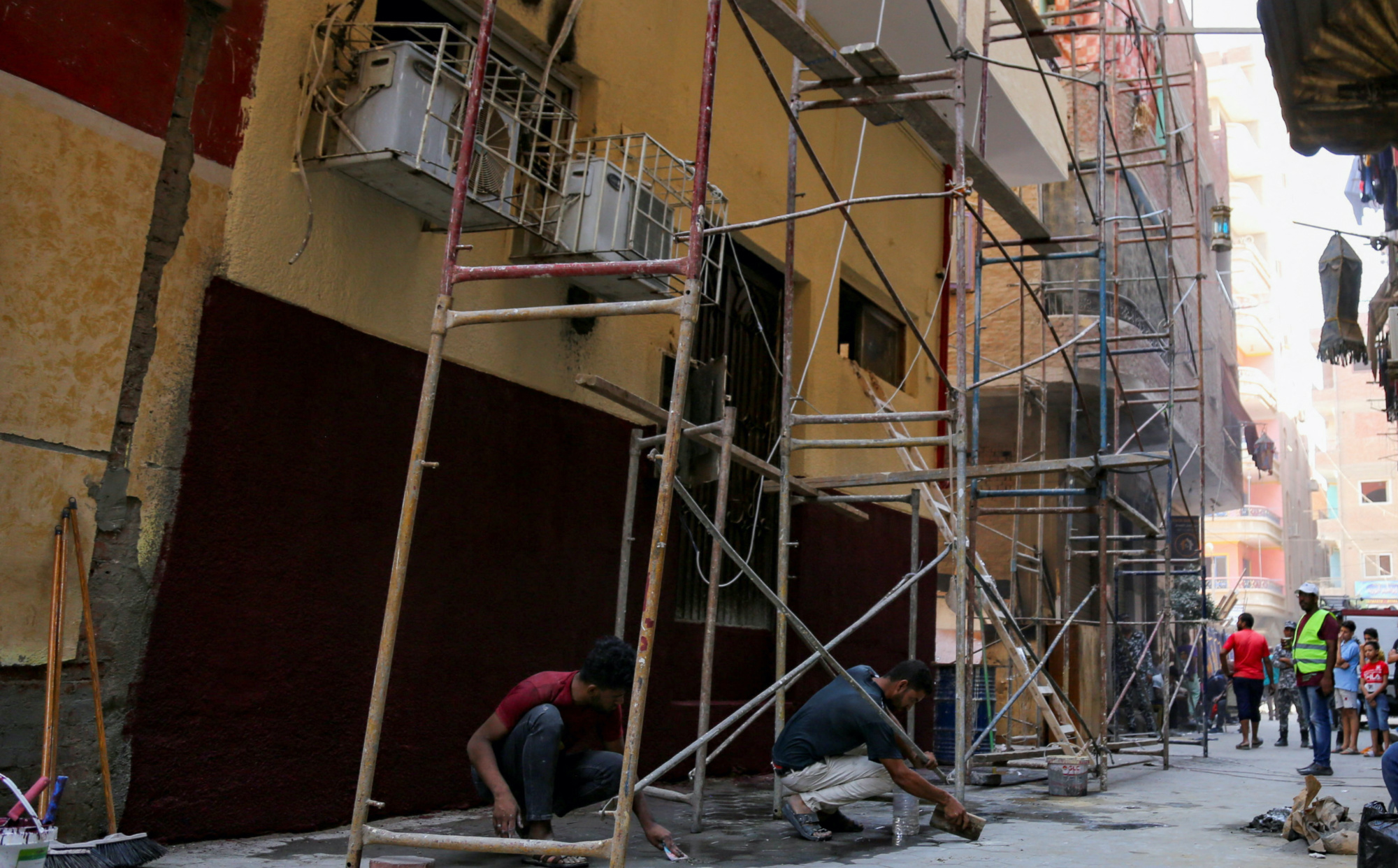 Egyptian employees start renovation works at burned Abu Sifin church after a deadly electrical fire broke out during Sunday Mass 15 August 2022 (Reuters)