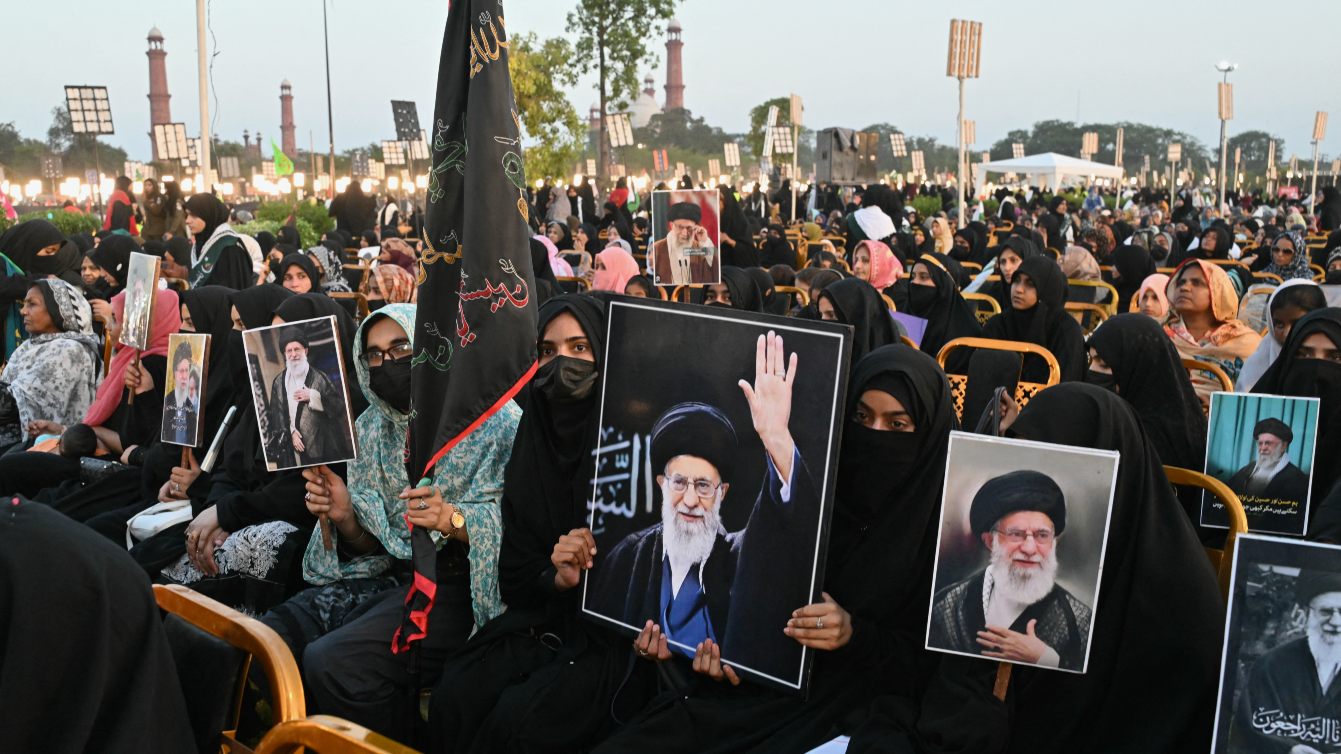 Activists carry portraits of slain Iranian leader Ali Khamenei during Shaheed-e-Ummat conference in Lahore, Pakistan, 13 June 2026 (Arif Ali/AFP)