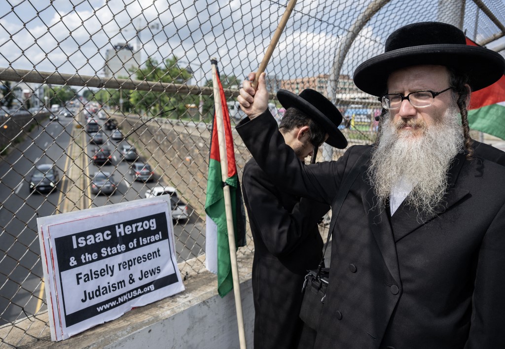 Activists with The Palestinian Youth Movement and the Party for Socialism and Liberation display a banner near the US Capitol in Washington, DC, on 19 July 2023 (AFP)