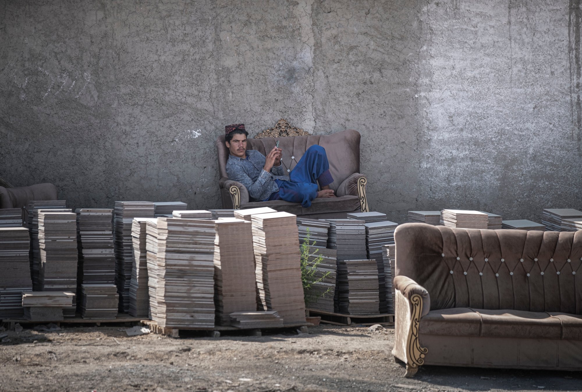 An Afghan man looks on in the Shahr-e-Rey neighbourhood south of Tehran, Iran, on 19 August 2021 (Reuters)