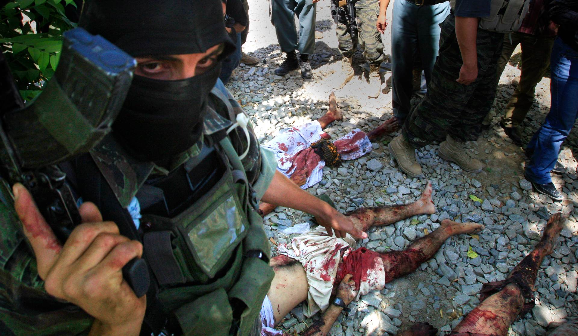 Afghan special forces show off the bodies of militants killed during a shootout in Kabul in 2009 (Peter Nicholls/The Times)