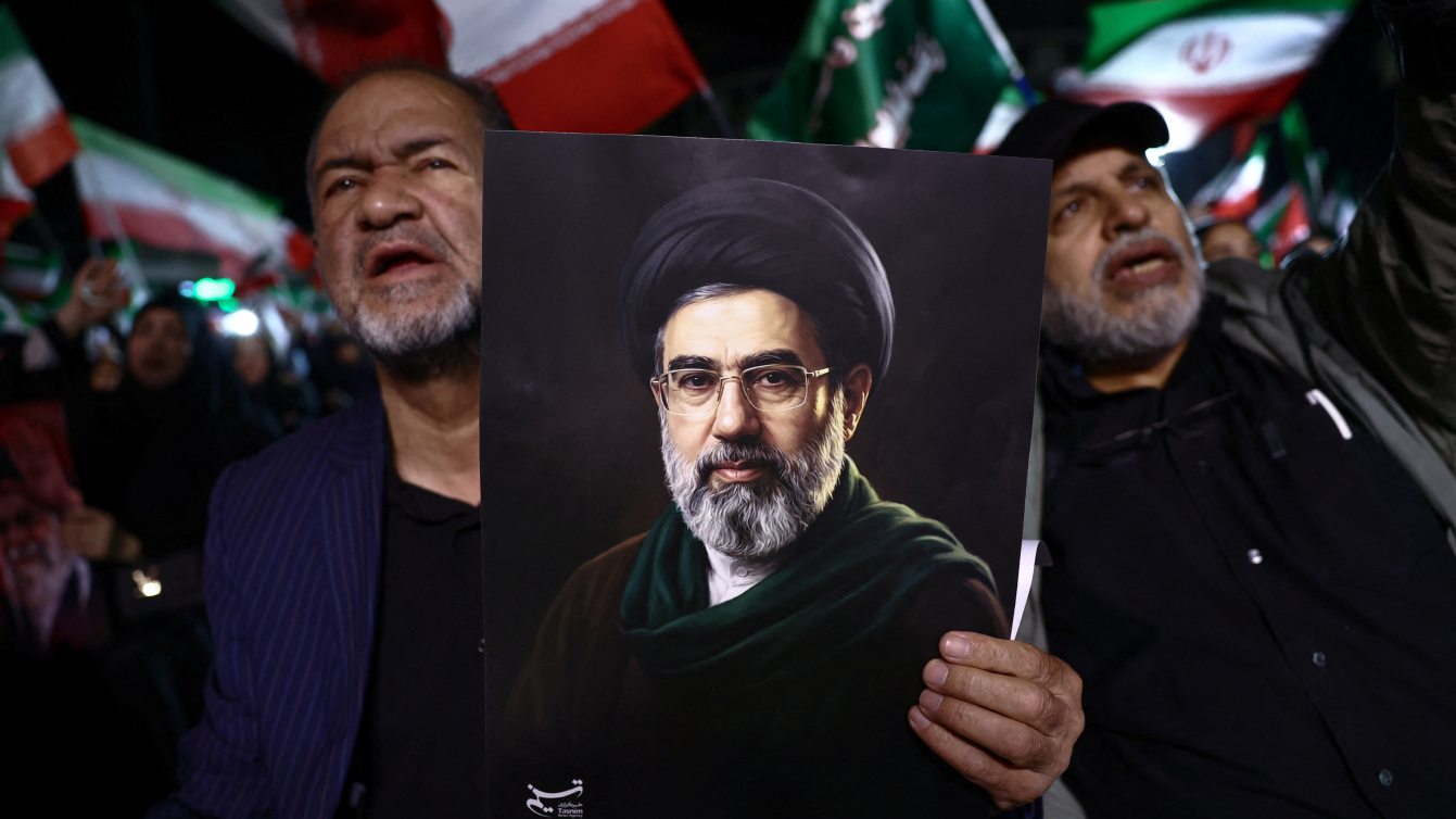 A man holds a poster with the image of Iran's new Supreme Leader, Mojtaba Khamenei, during an anti-U.S. and Israeli rally, amid the U.S.-Israeli conflict with Iran, in Tehran, Iran, March 22, 2026. Majid Asgaripour/WANA (West Asia News Agency) via REUTERS
