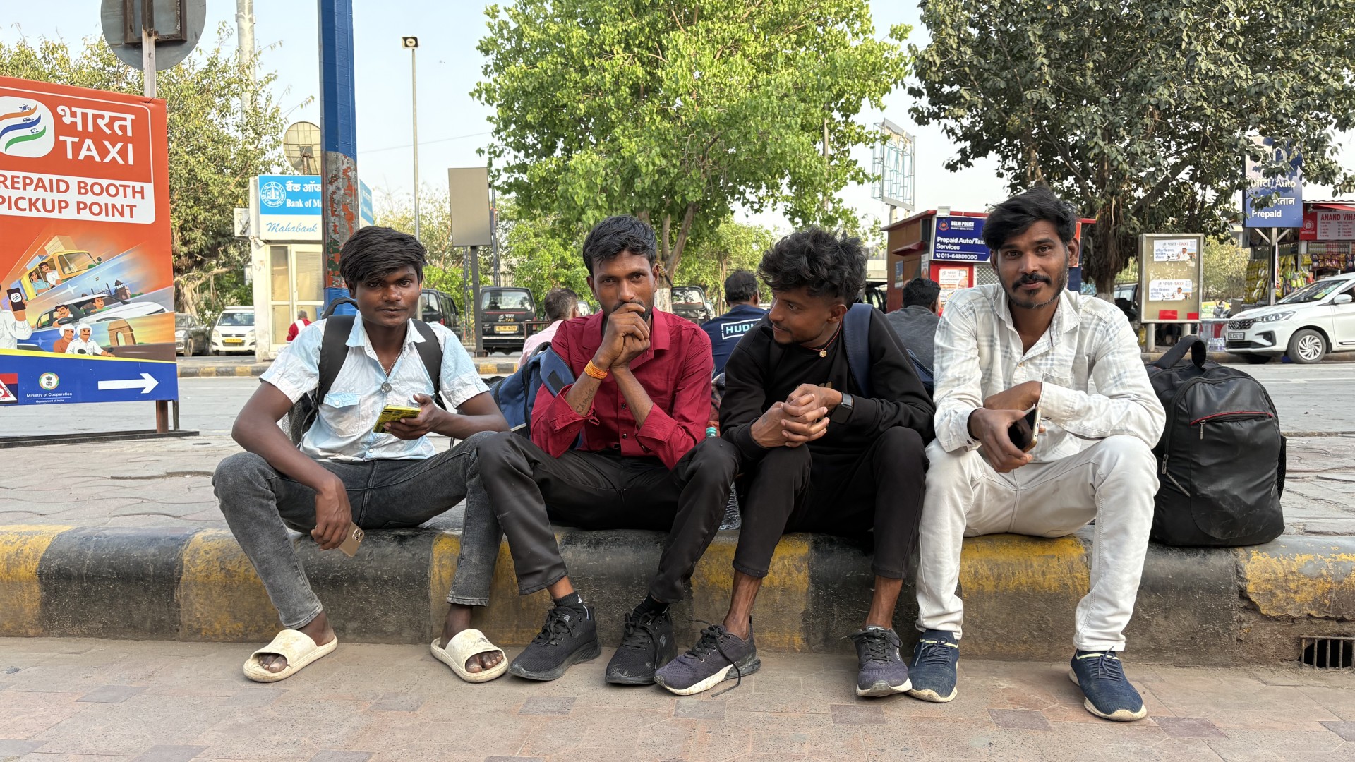 Ashok Kumar Chaudhary, second left, with his co-workers at Anand Vihar railway station in New Delhi, as they wait for the train to their village in Jharkhand
