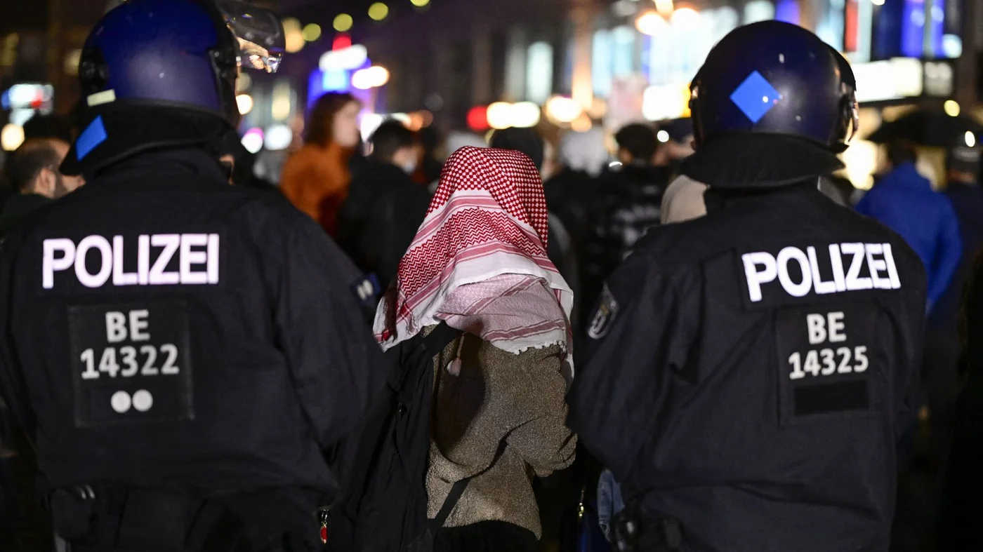 Police prevent protesters taking part in a banned pro-Palestinian demonstation at Red Town Hall in Berlin's Alexanderplatz on 7 October (AFP/John Macdougall)