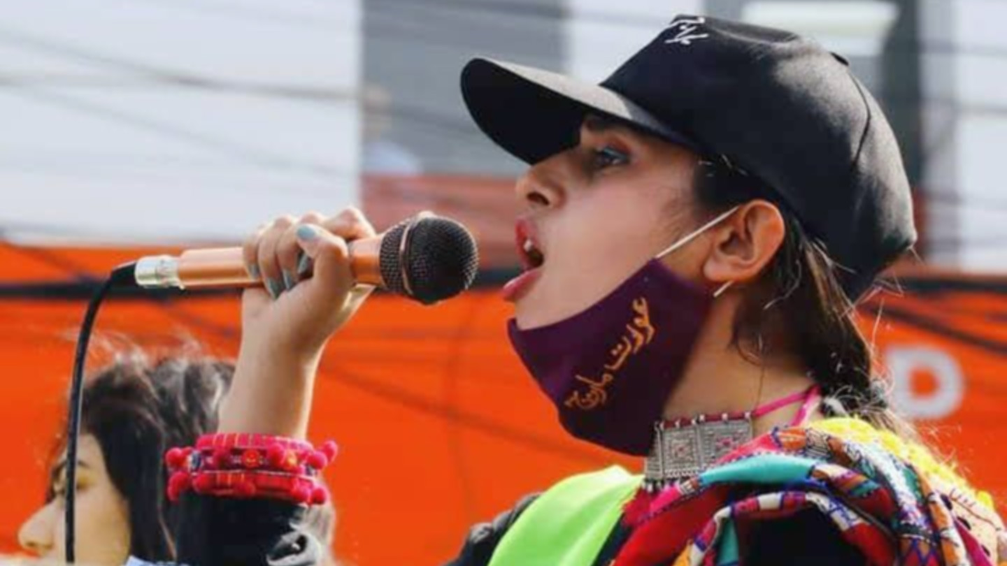 Mahwari Justice organiser Bushra Mahnoor, 26, addresses a crowd at Aurat March Lahore in 2022, advocating for gender equality in Pakistan (supplied)