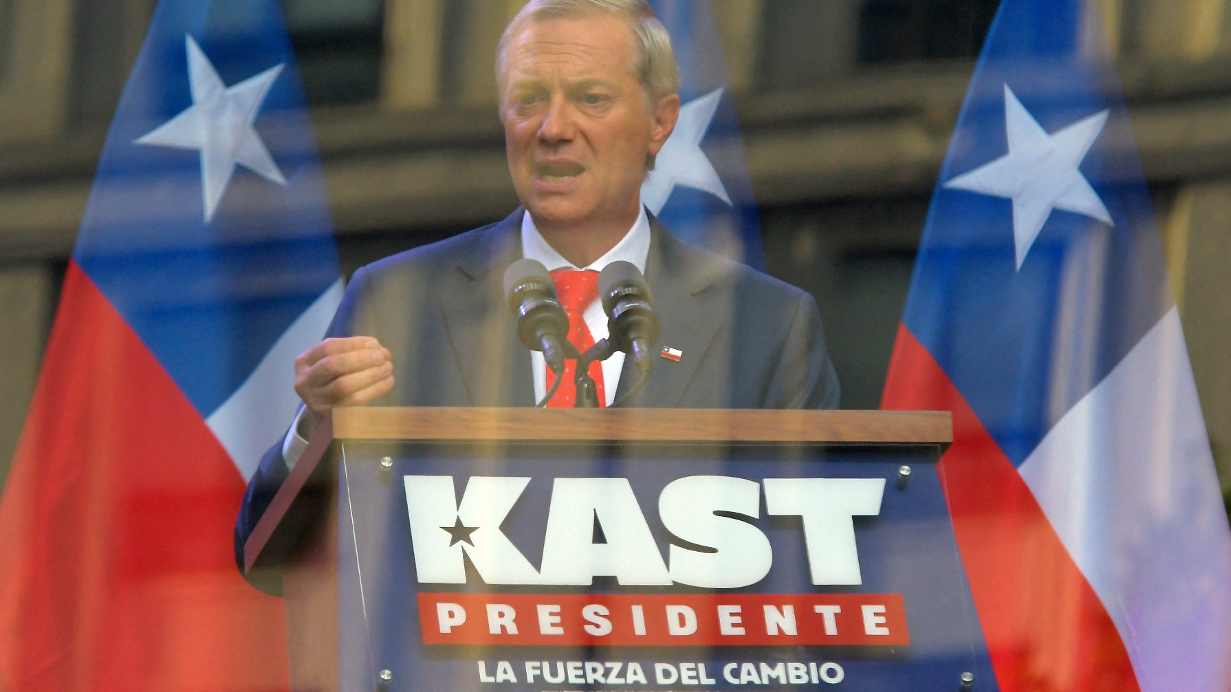 Chilean presidential candidate Jose Antonio Kast of the Republican Party delivers a speech behind bulletproof glass during his closing campaign rally in Concepcion, Chile, on December 6, 2025