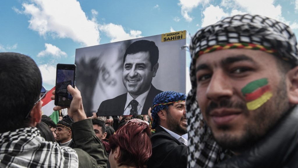 People hold a portrait of Selehattin Demirtas during a gathering of Turkish Kurds for Nowruz (aka Noruz or Newroz) celebrations in March 2025 (AFP)