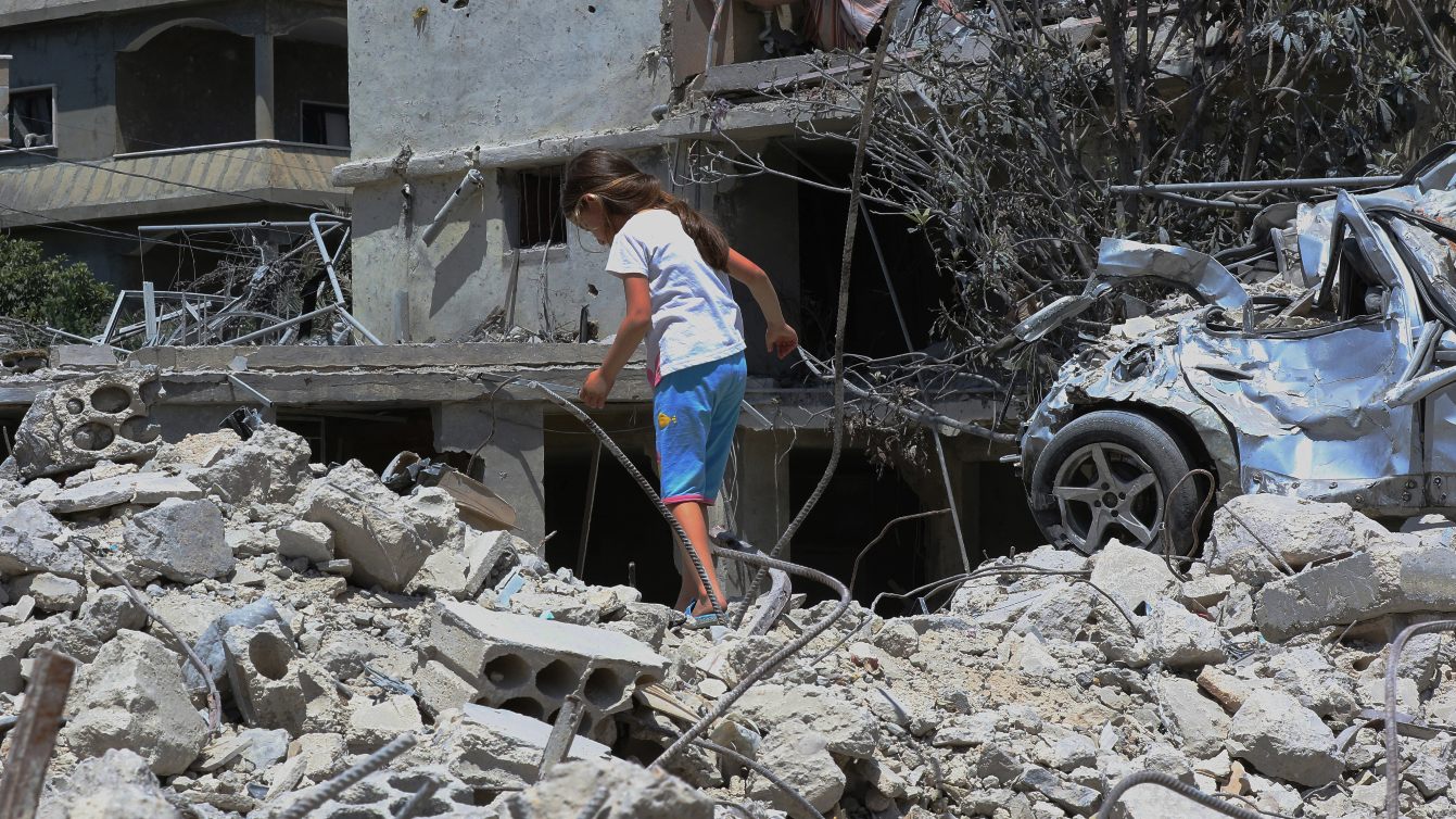 Displaced girl walks atop her family’s destroyed home in Deir Qanoun en Nhar, southern Lebanon, 15 June 2026 (Mahmoud Zayyat/AFP)