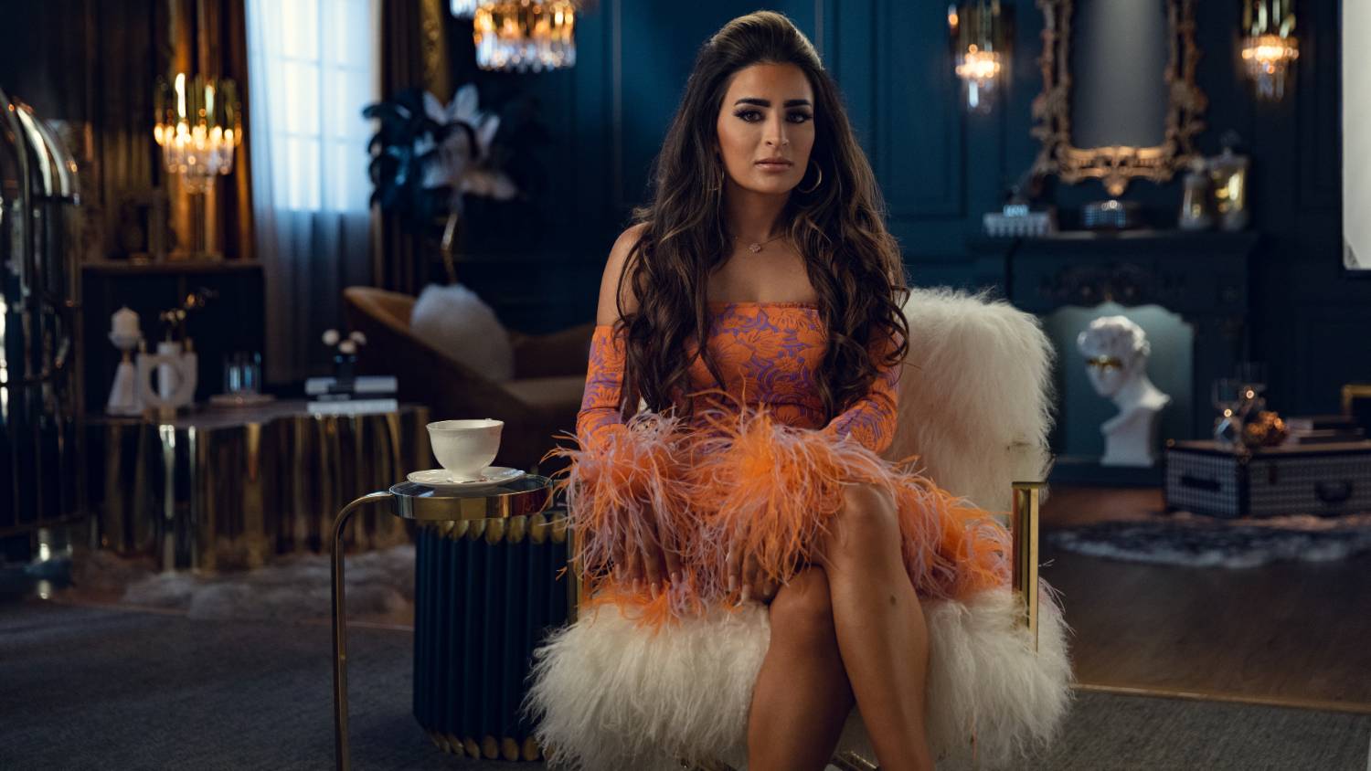 Cast members, like Safa Siddiqui above, are filmed wearing over the top outfits as they wander around an unrecognisable Dubai (Netflix)