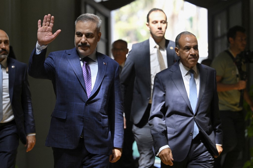 Egypt's Foreign Minister Badr Abdel Ati (R) walks with his Turkish counerpart Hakan Fidan (L) ahead of their meeting in Cairo on June 21, 2026. 