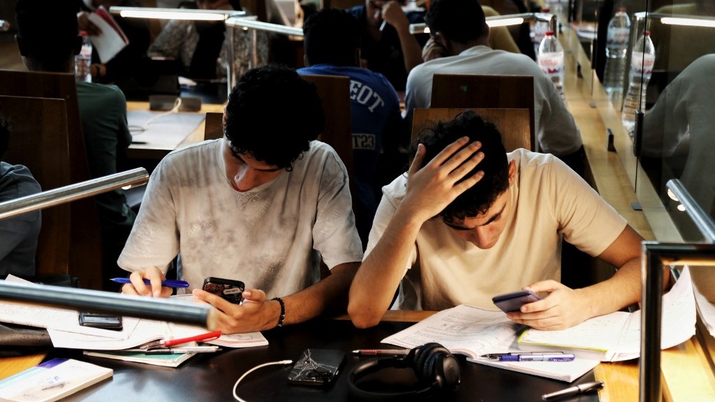 A picture taken on June 28, 2024 in the Mediterranean city of Alexandria, shows Egyptian high school students keeping cool by studying in the Alexandria Library, as Egypt began implementing planned power cuts in an attempt to ease the load on the local electricity networks as energy consumption surges during the hot summer months. 