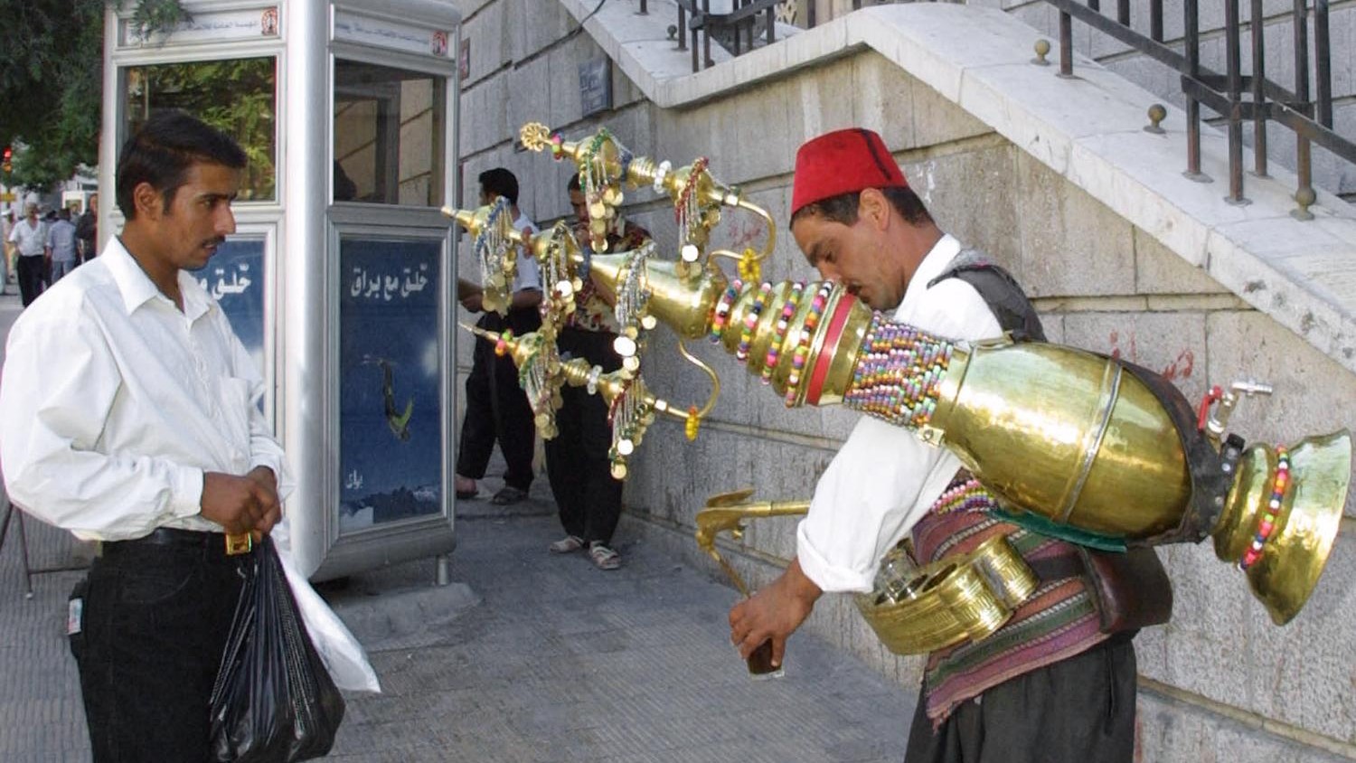 A Syrian man sells the traditional liquorice drink on the street in Damascus' old quarter (AFP/ Louai Beshara)