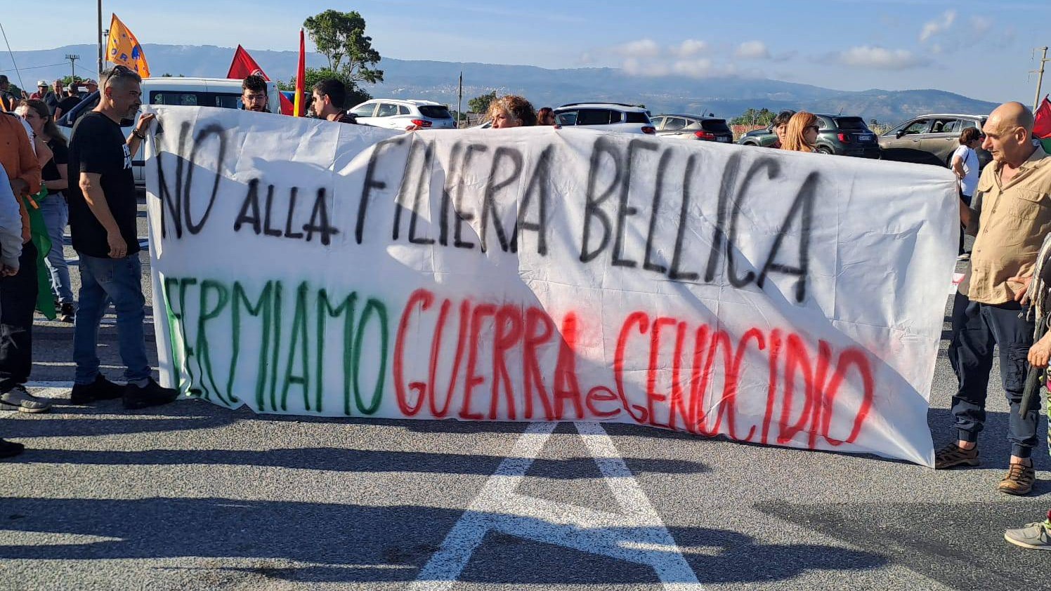 Activists hold a placard reading: 'No to the war supply chain - let's stop the war of genocide' (Dalia Ismail/MEE)