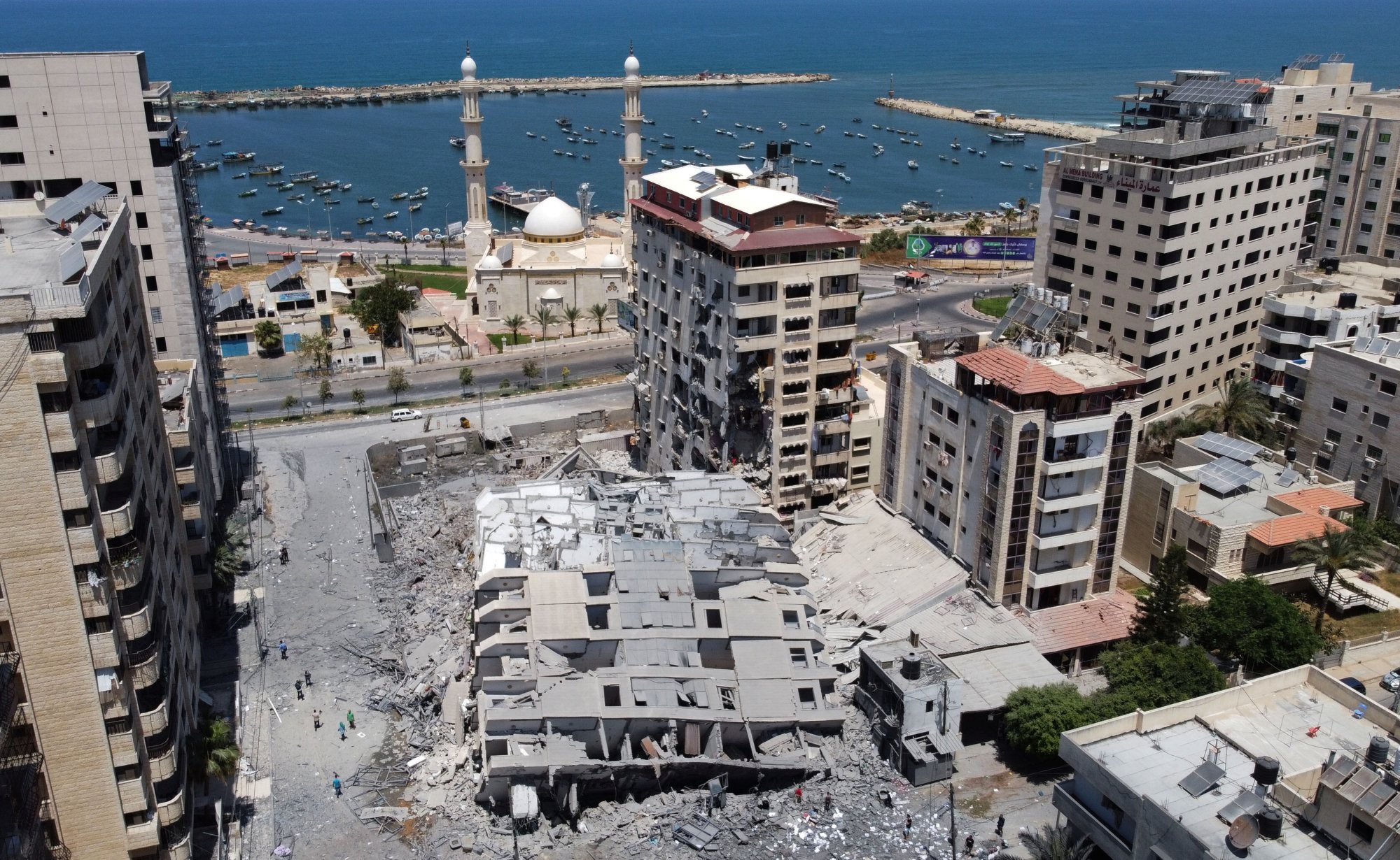 The remains of a tower building are visible in Gaza City on 12 May 2021 after Israeli air strikes (Reuters/Mohammed Salem)