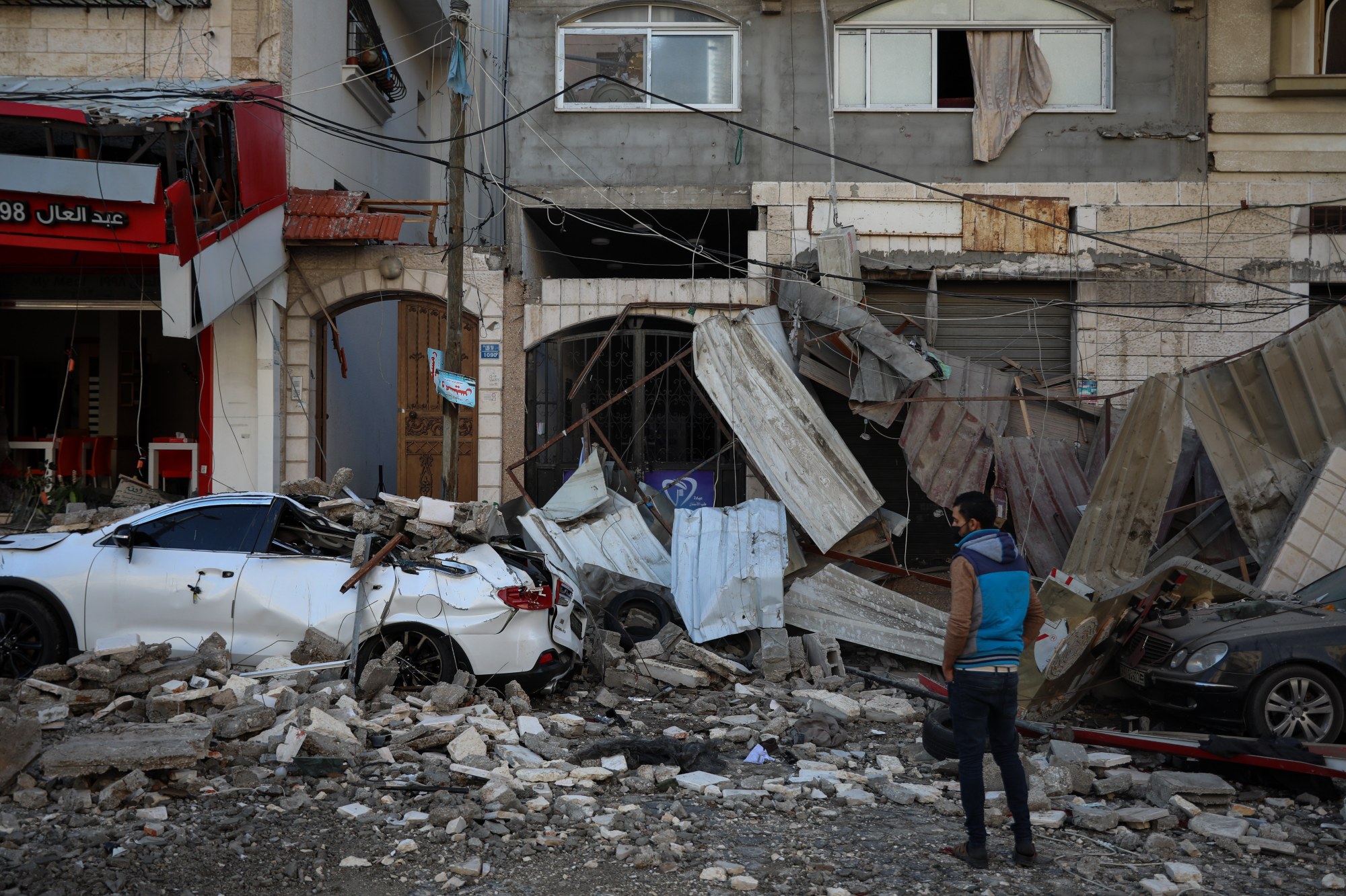 A Palestinian inspects damages in the aftermath of an Israeli air strike on Gaza City on 12 May 2021 (MEE/Mohammed al-Hajjar)