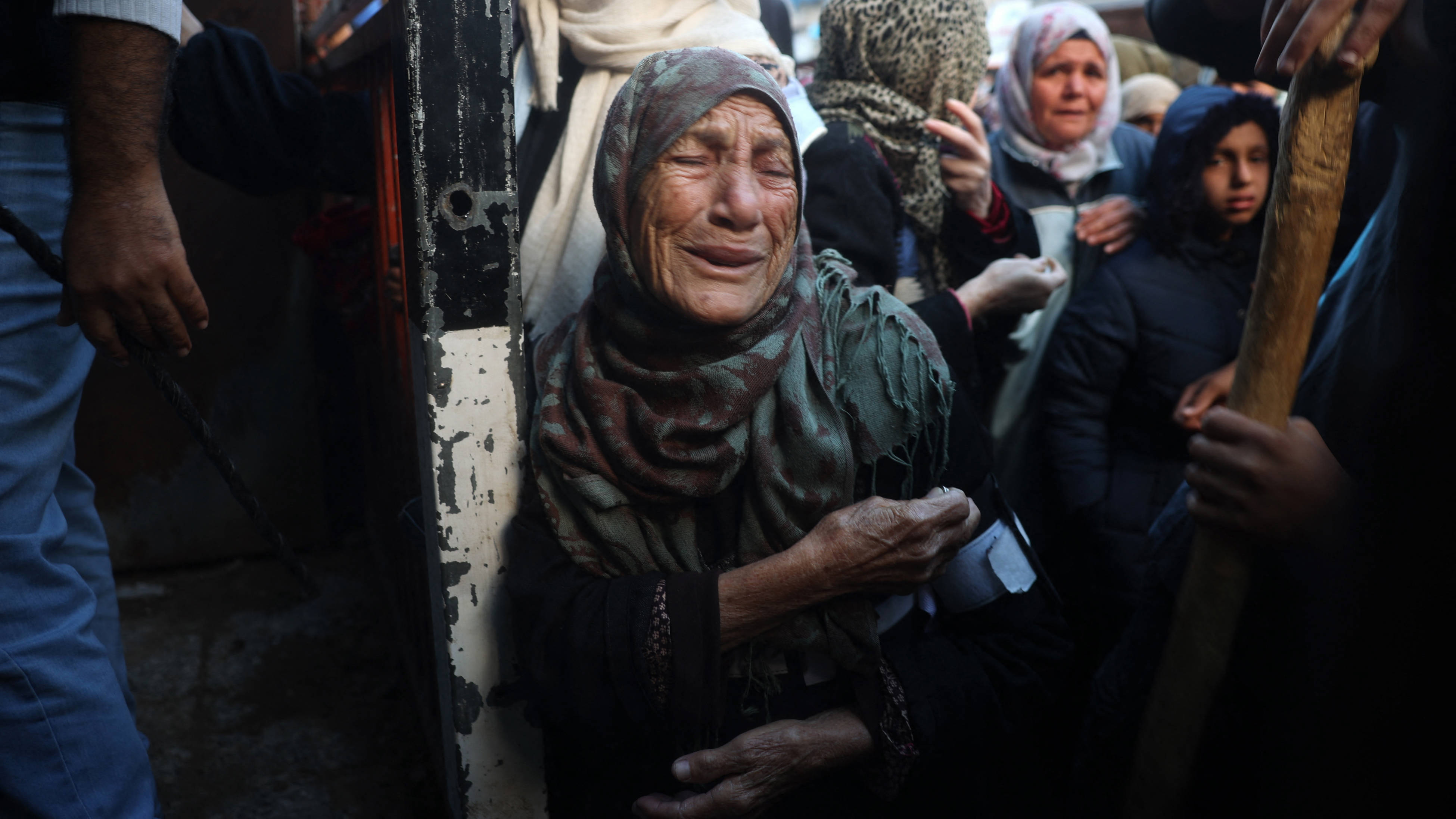 Palestinians wait for bread outside a bakery in the Nuseirat camp in central Gaza on 27 November 2024 (AFP)
