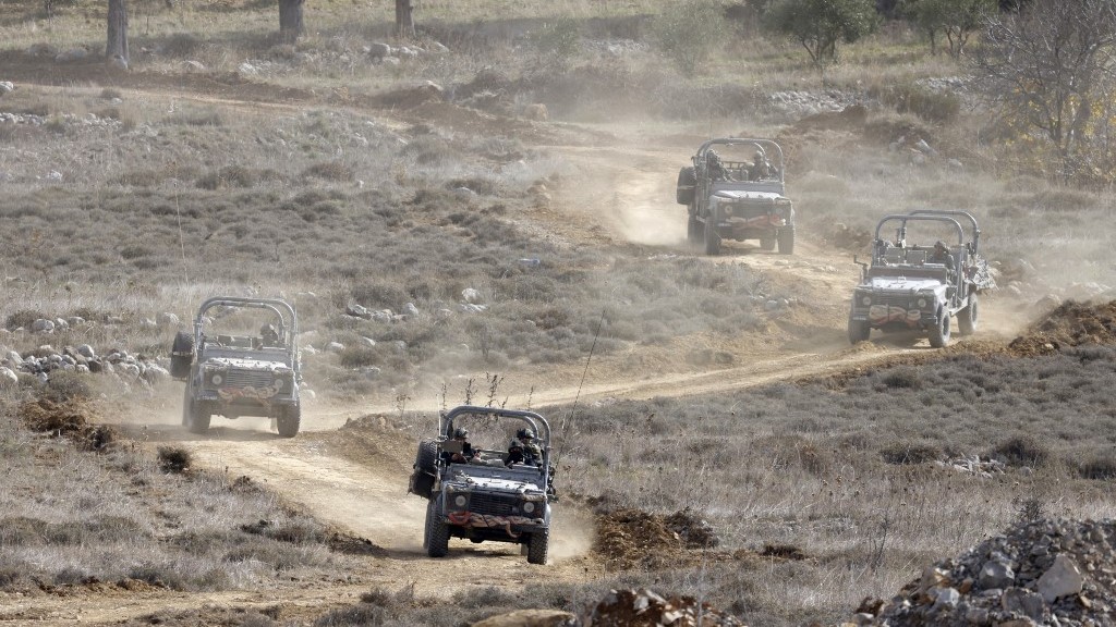 Israeli military vehicles return from the buffer zone with Syria, near the Druze village of Majdal Shams in the Israel-annexed Golan Heights, on December 11, 2024
