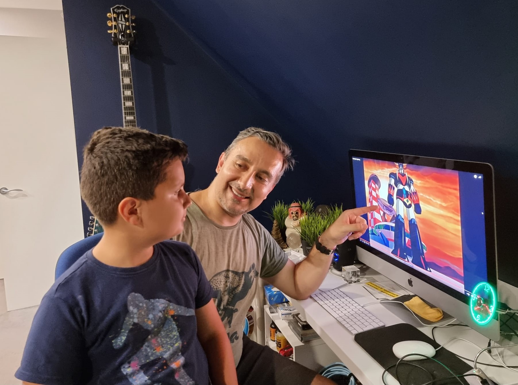 Bassam Aldhahir (right) now shares the animes of his childhood, like Grendizer, with his own children (Credit: Bassam Aldhahir)