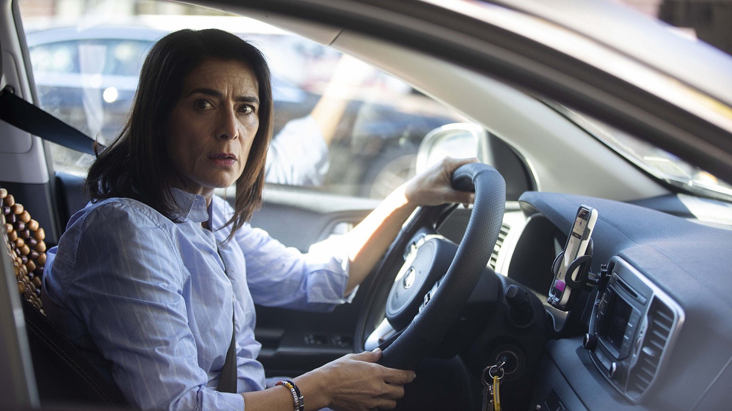 Ramy's mother, as played Hiam Abbass, briefly breaks out of her static life when she works as a taxi driver (Hulu)by Hulu  ​