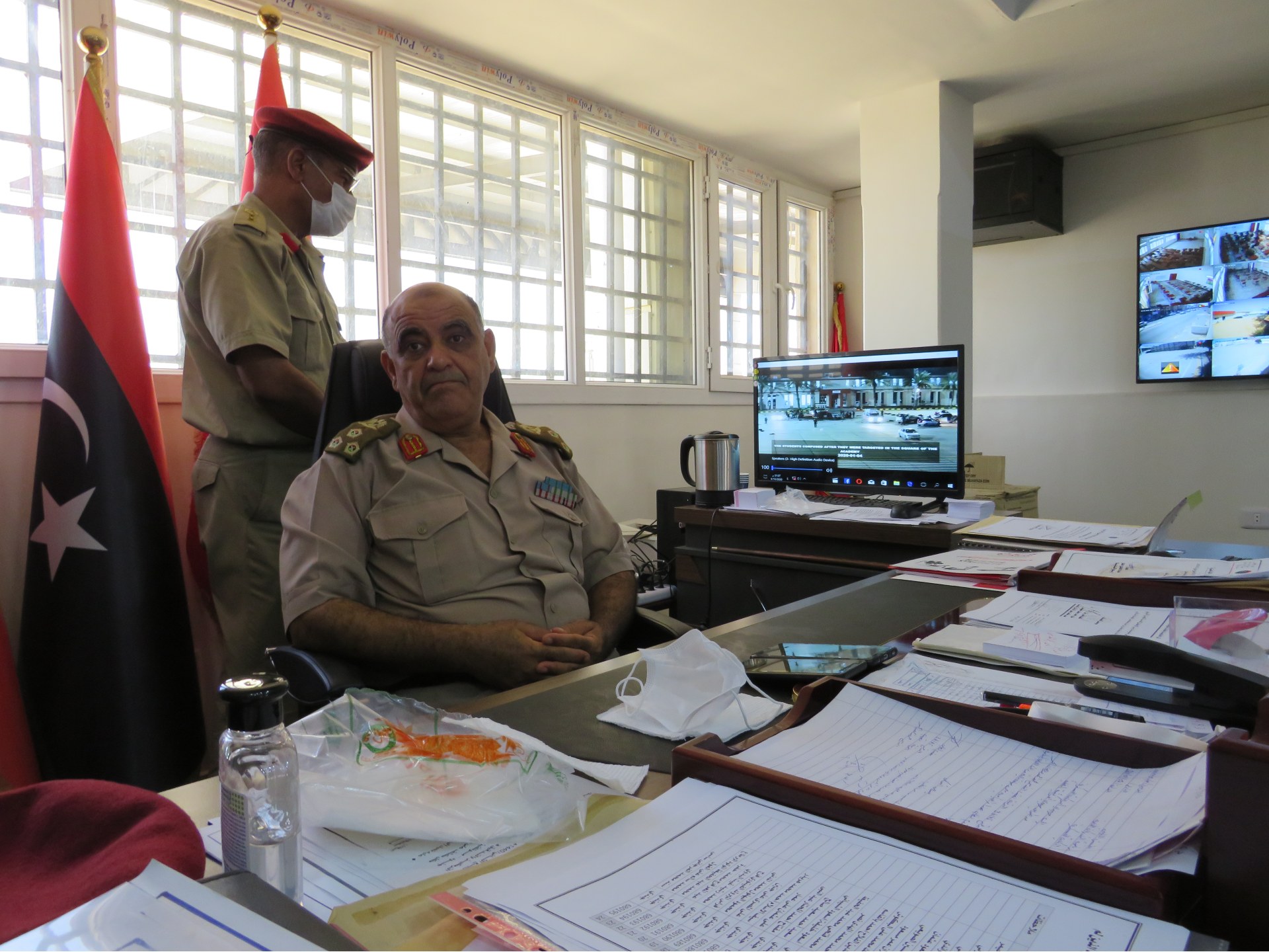 Brigadier General Khaled Ali Ahmed bin Omar turns away from a screen showing footage of the bombing (MEE/Daniel Hilton)
