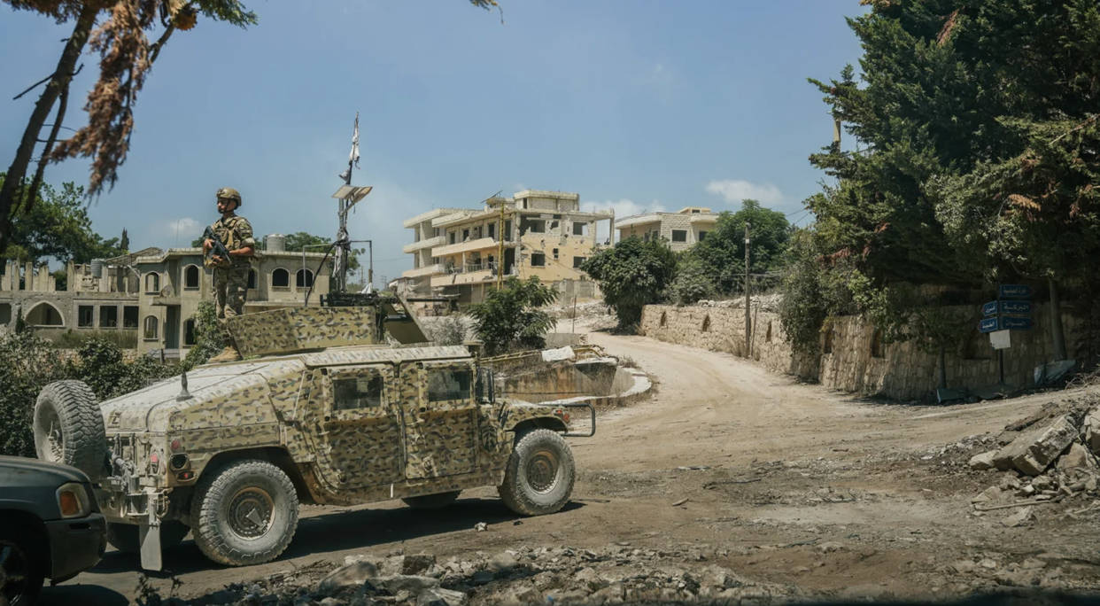 A Lebanese soldier stands guard at the entrance to Zawtar al-Gharbiyeh, one of three southern Lebanese villages designated as a “pilot zone” under an Israel-Lebanon framework agreement (Giovanna Vial/MEE)