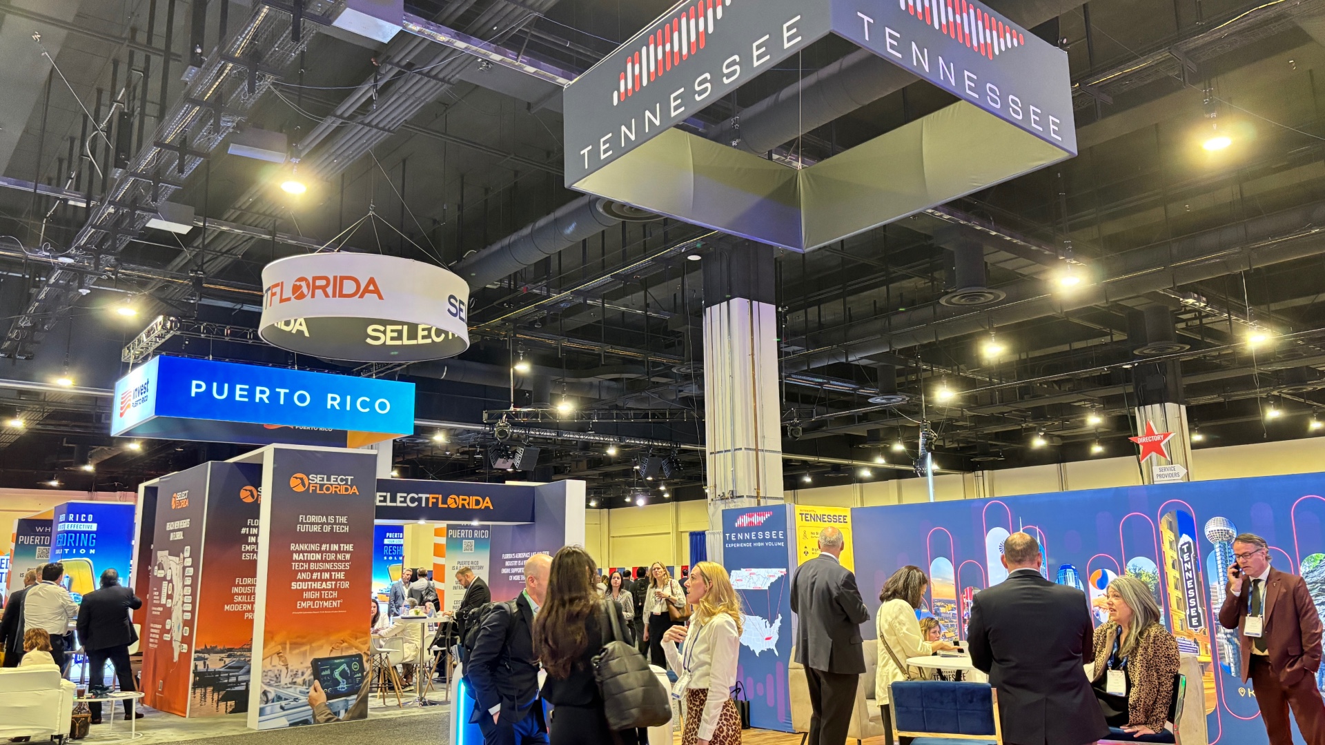 A view of the exhibit hall at the 2026 SelectUSA Investment Summit shows the Tennessee, Florida, and Puerto Rico pavilions
