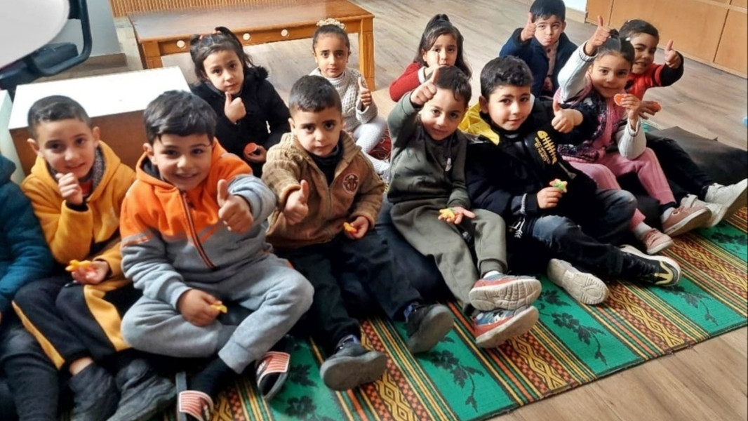 Palestinian children sit in a classroom renovated by kindergarten teacher Doaa, where she resumed lessons after her original school was destroyed, in the Maghazi refugee camp on 26 February 2025 (Supplied)
