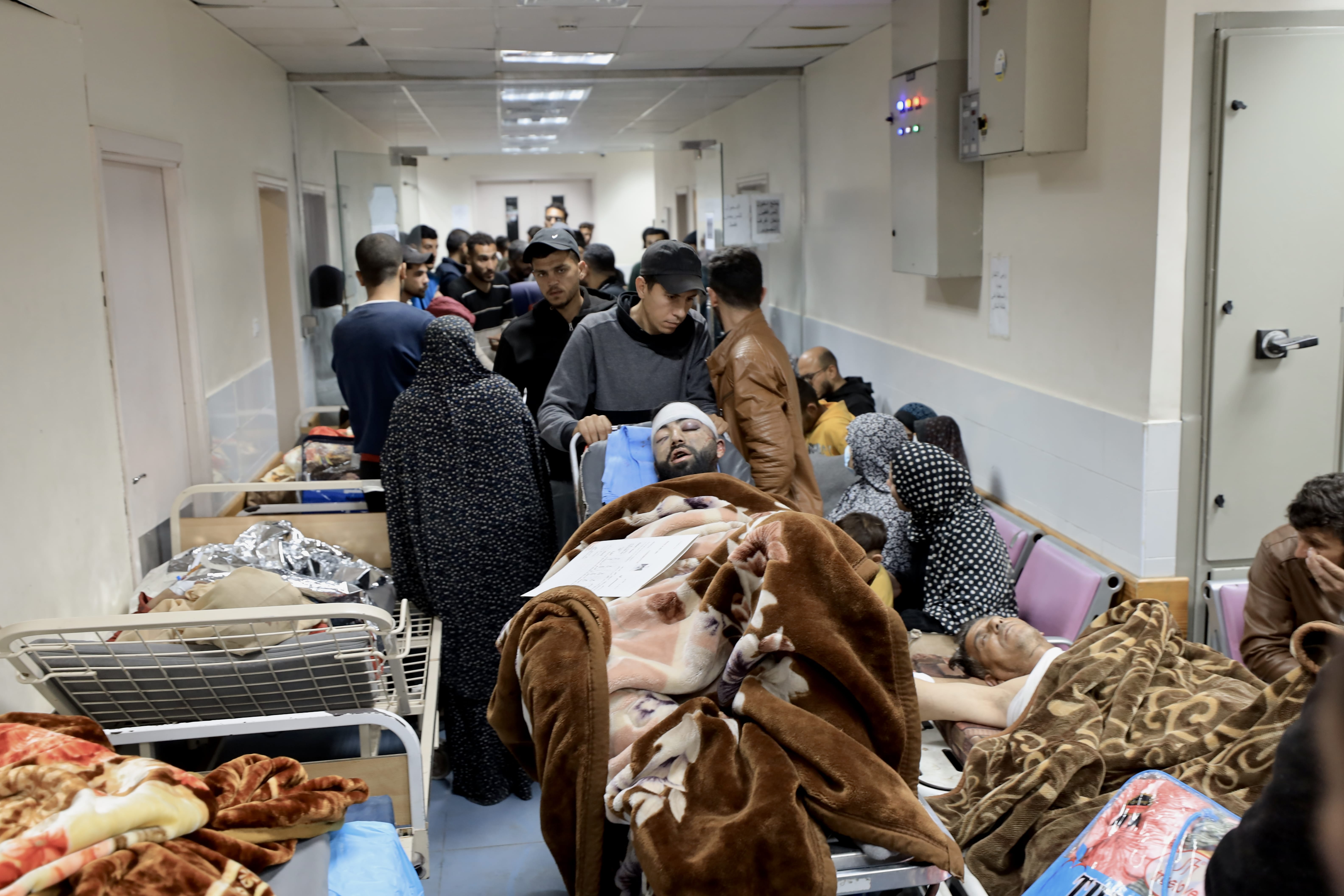Injured Palestinians wait for treatment at the hospital following Israeli air strikes on Gaza Strip, early on Tuesday. (Mohammed al-Najjar/MEE)