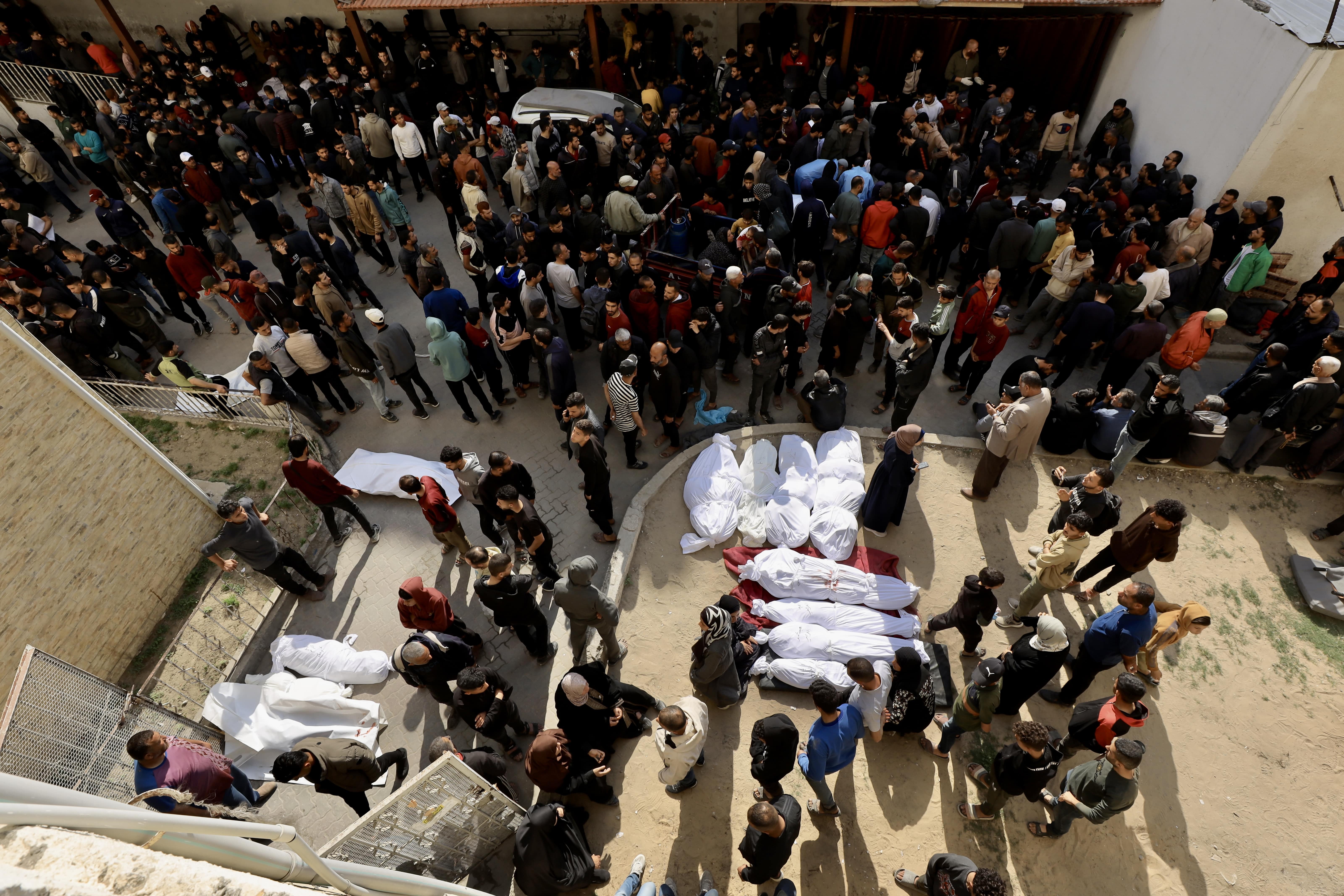 Mourners gather near the bodies of Palestinians killed in Israeli strikes on Gaza, 18 March, 2025. (Mohammad al-Najjar/MEE)