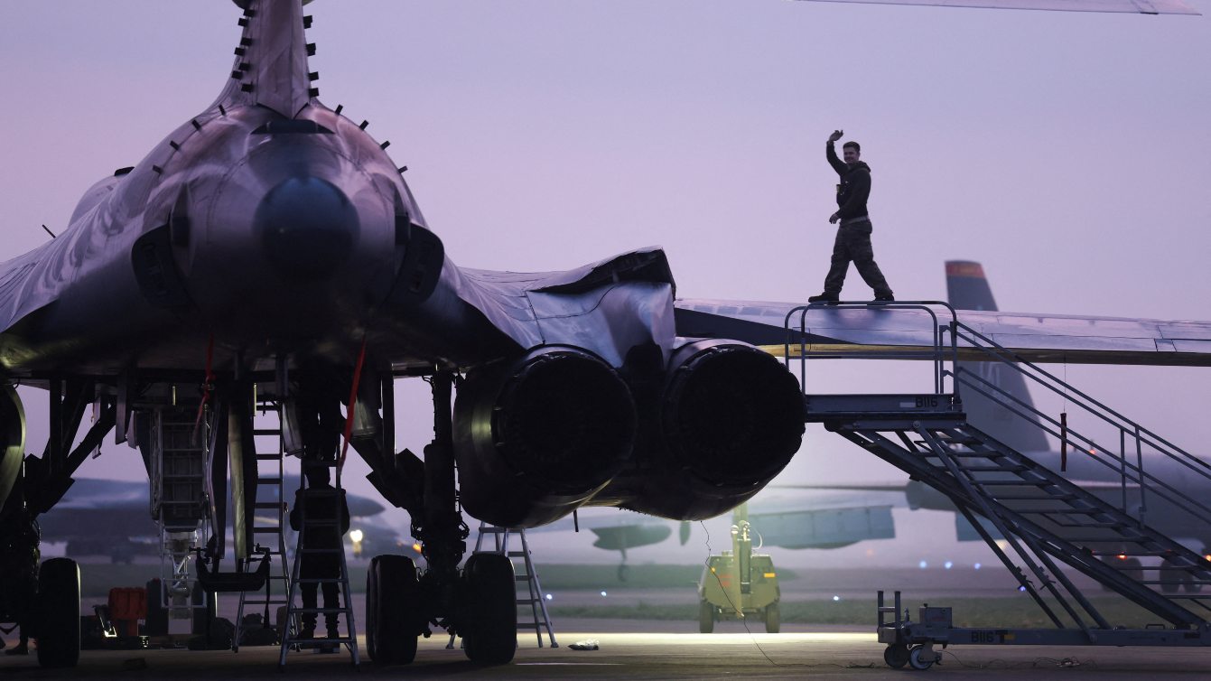 A member of the ground crew prepares a USAF B-1 bomber before dawn at RAF Fairford airbase, used by United States Air Force (USAF) personnel, amid the U.S.–Israeli conflict with Iran, in Fairford, Gloucestershire, Britain, March 23, 2026. REUTERS/Toby Shepheard