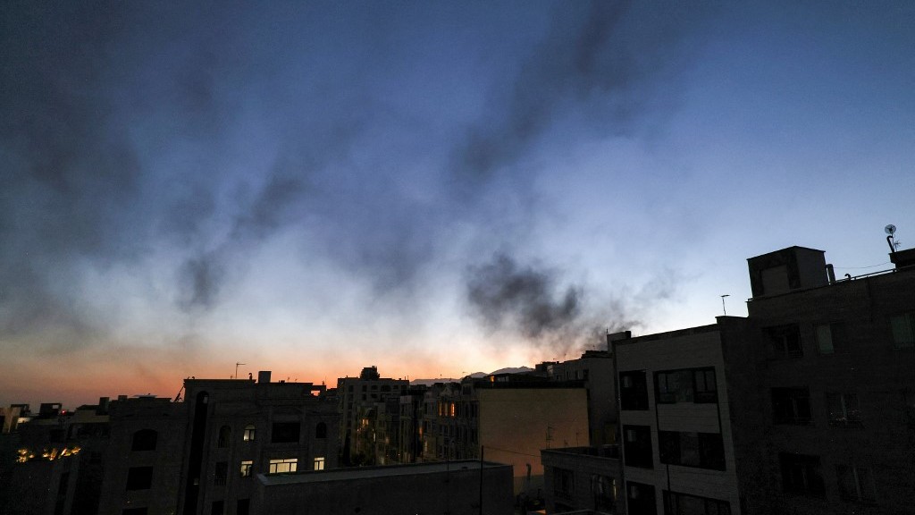 Smoke plumes billow following an overnight Israeli strike on Tehran on June 17, 2025  (Atta Kenare / AFP)