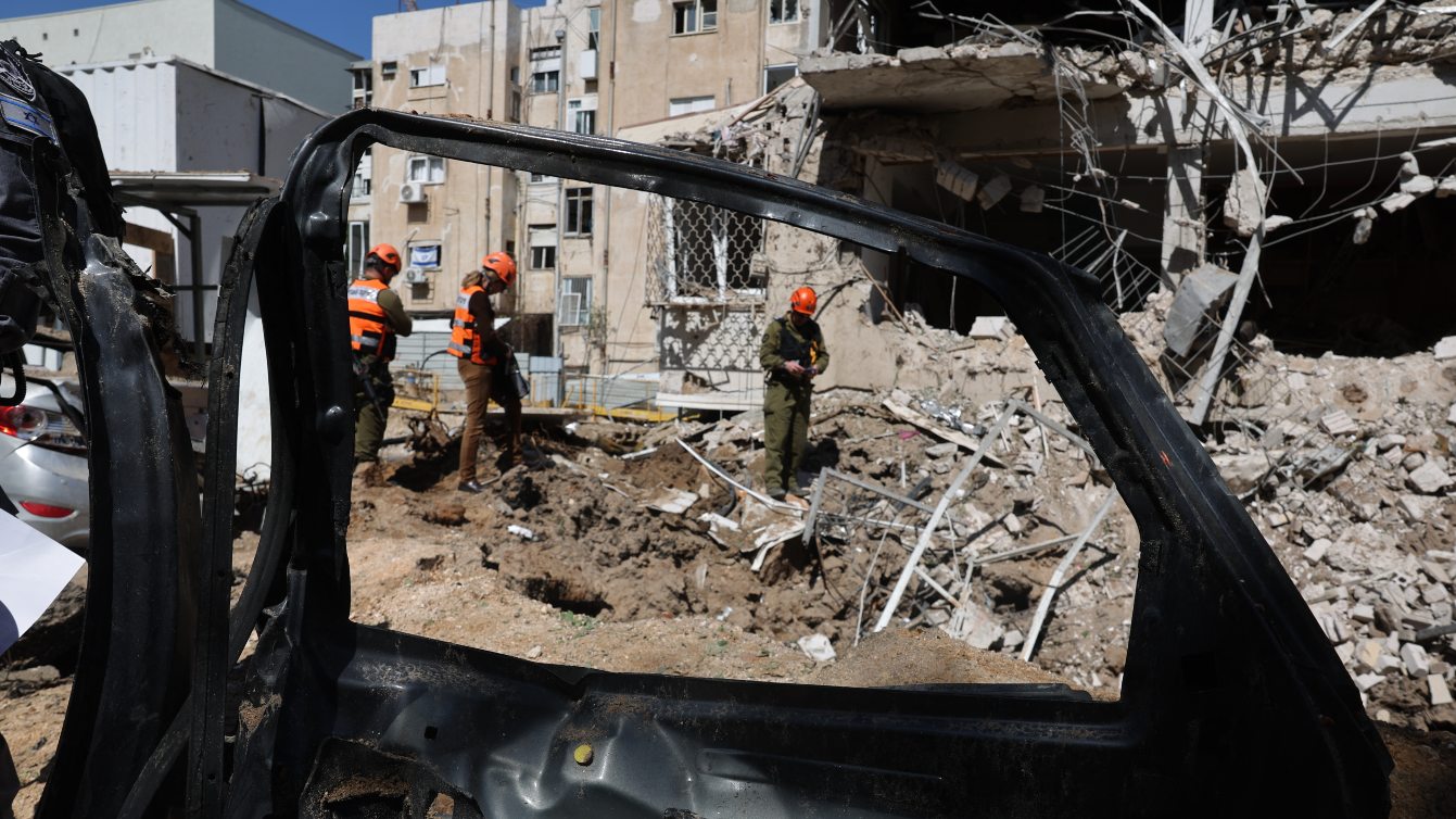 Israeli emergency service personnel gather at the site of an Iranian missile strike in Tel Aviv on 24 March 2026. Jack GUEZ / AFP