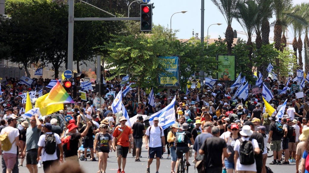 Demonstrators raise flags during an anti-government protest demanding a deal to release Israelis detained in the Gaza Strip by Hamas since October 7, 2023, in Tel Aviv on August 17, 2025 (AFP)